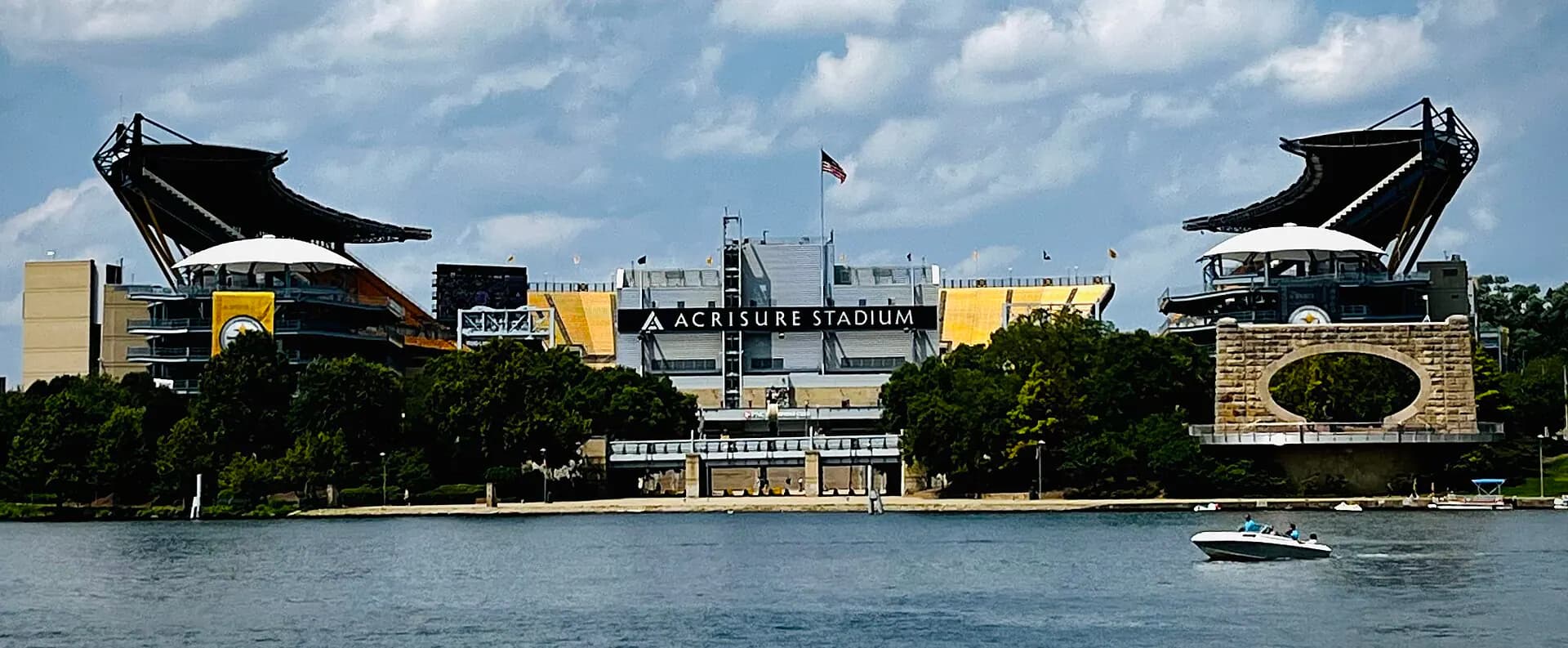 Exterior of Acrisure Stadium beside Pittsburgh's North Shore riverfront.