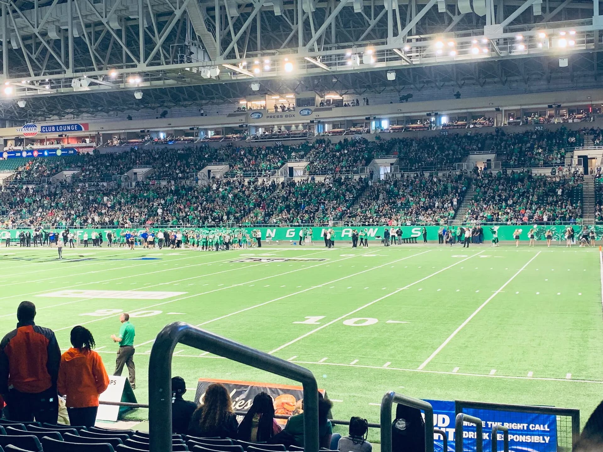 Wide interior view of the football field and seating bowl at Alerus Center.