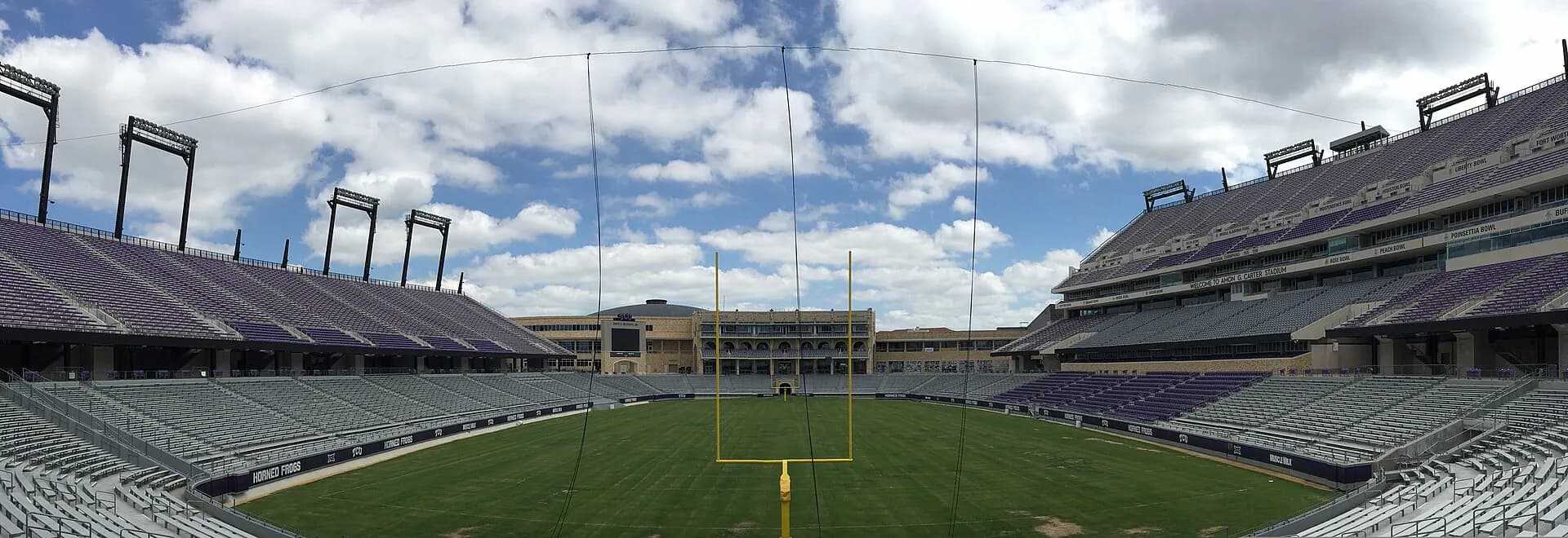 A wide interior view of Amon G. Carter Stadium's football field and seating bowl.