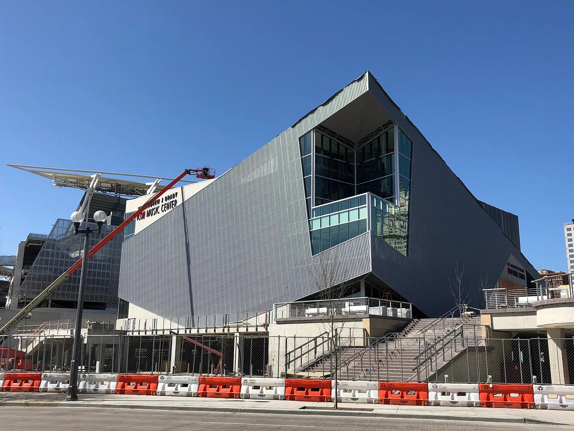 Wide exterior view of the Andrew J Brady Music Center beside Cincinnati's riverfront.