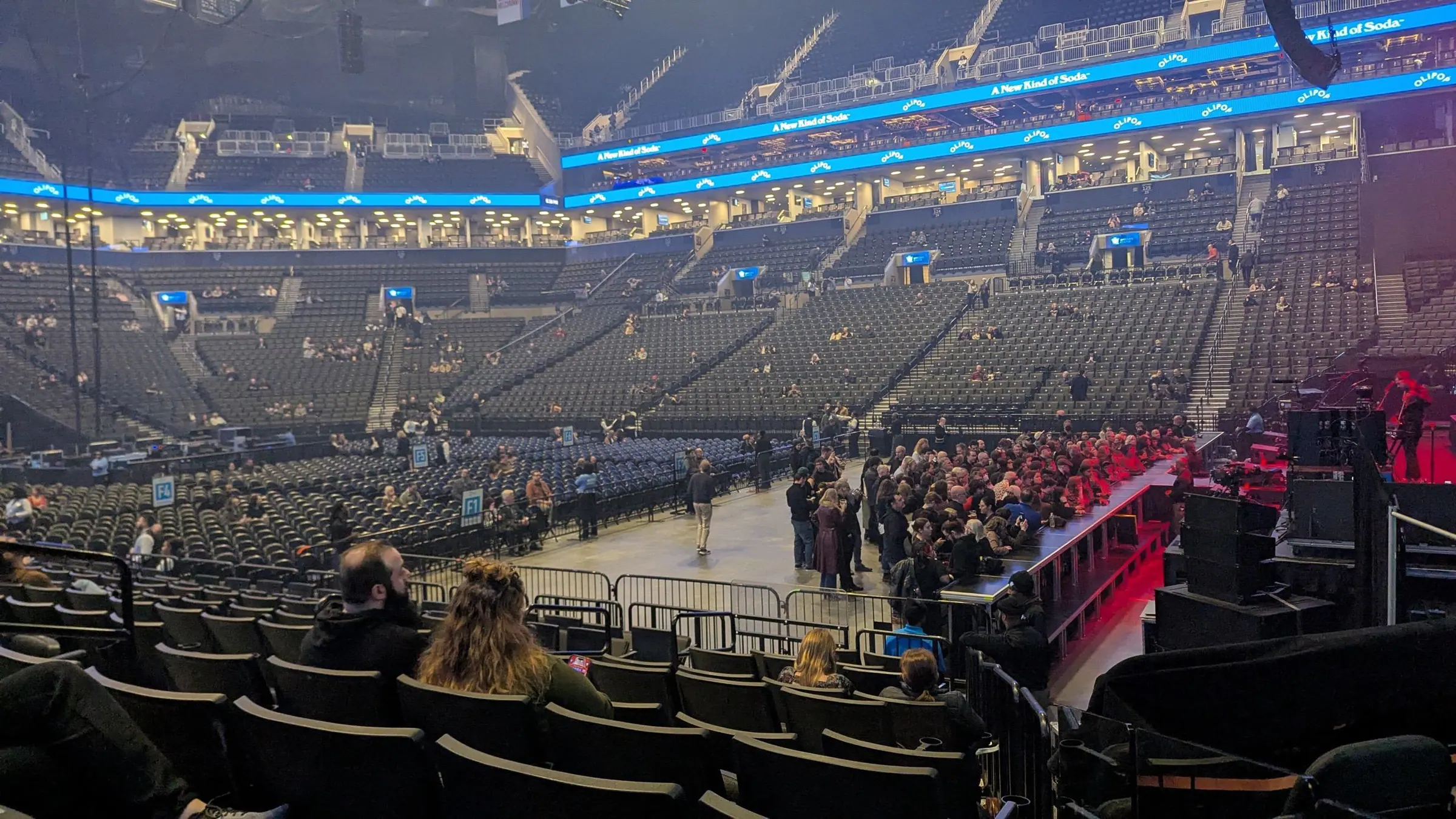 Wide fan-level view across the concert floor, stage setup, and seating bowl inside Barclays Center.