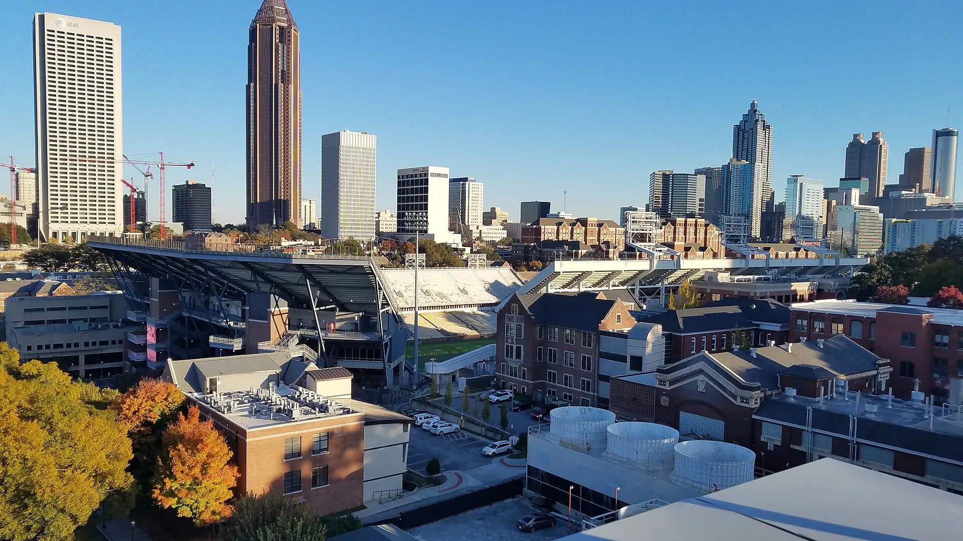 Wide view of Bobby Dodd Stadium and the Atlanta skyline beyond the bowl.