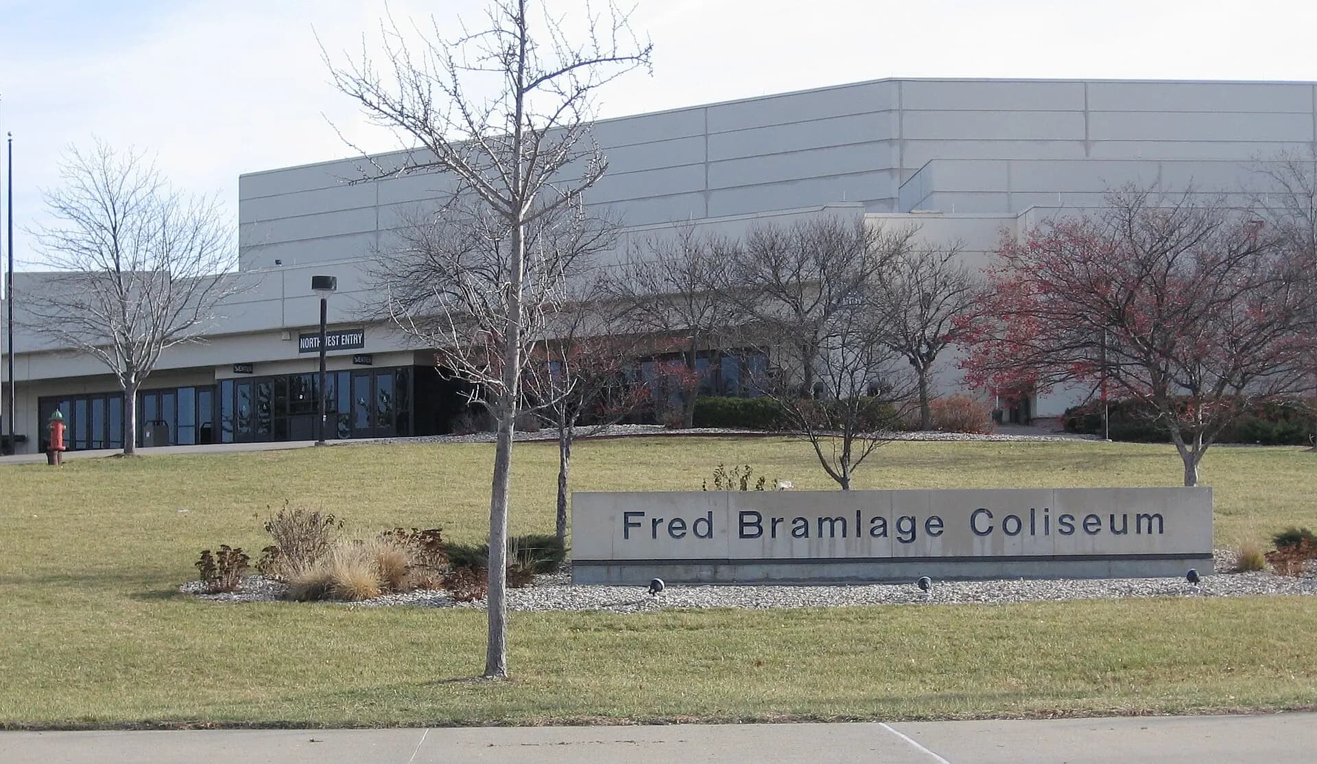 Exterior establishing view of Bramlage Coliseum and its entrance monument on the Kansas State campus.