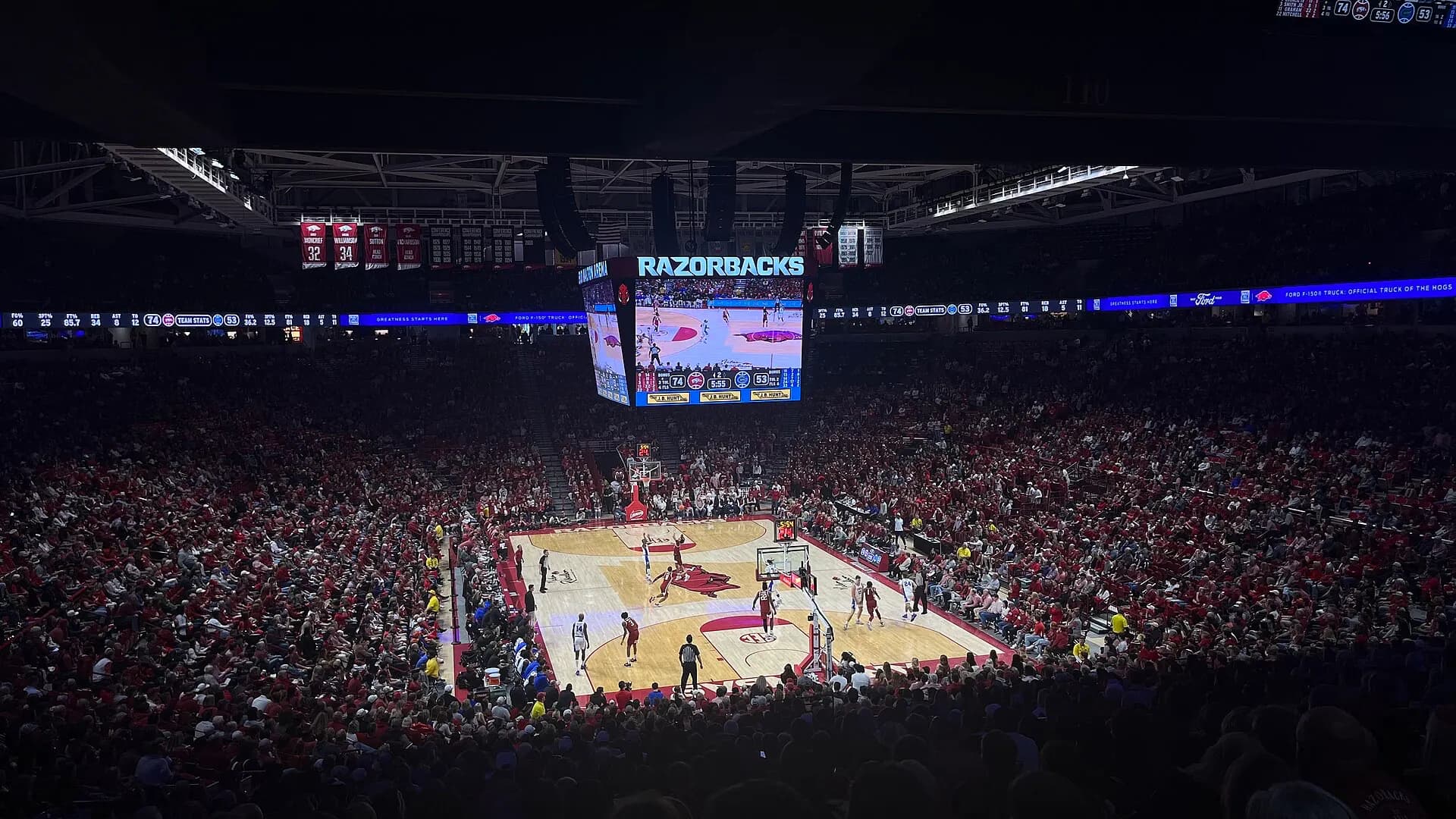 The basketball court and seating bowl during a game at Bud Walton Arena.