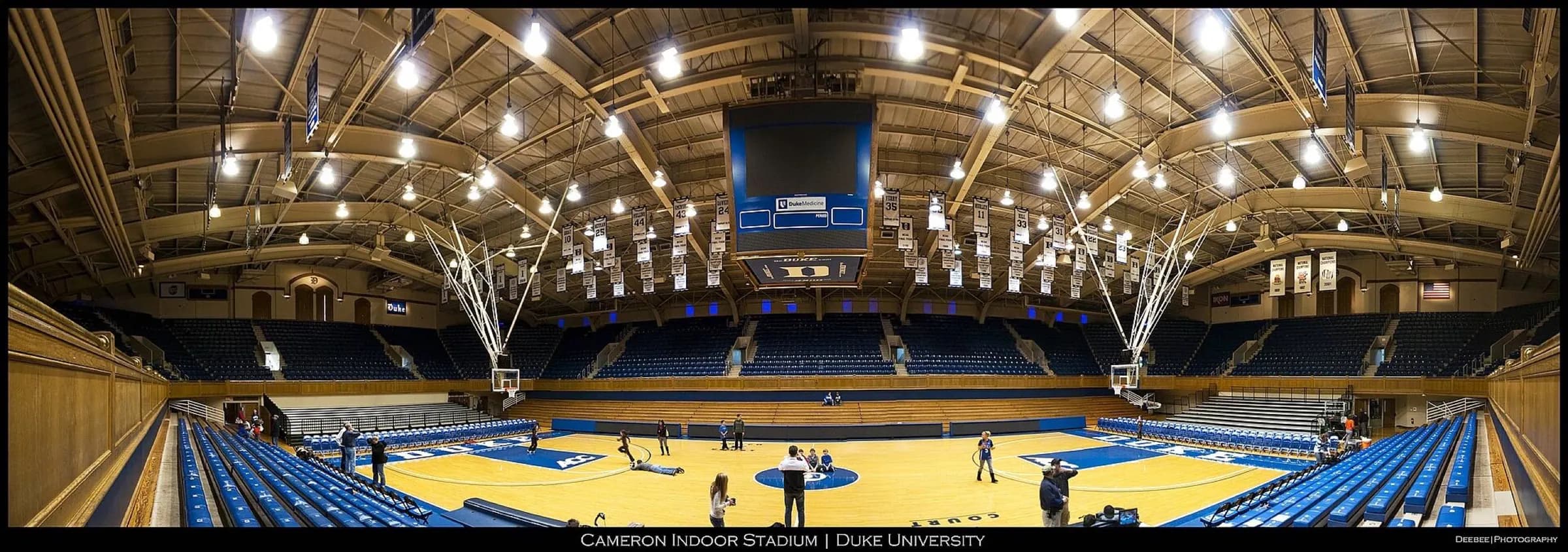 Wide empty-bowl panorama of Cameron Indoor Stadium, including the court, seating, scoreboard, and rafters.
