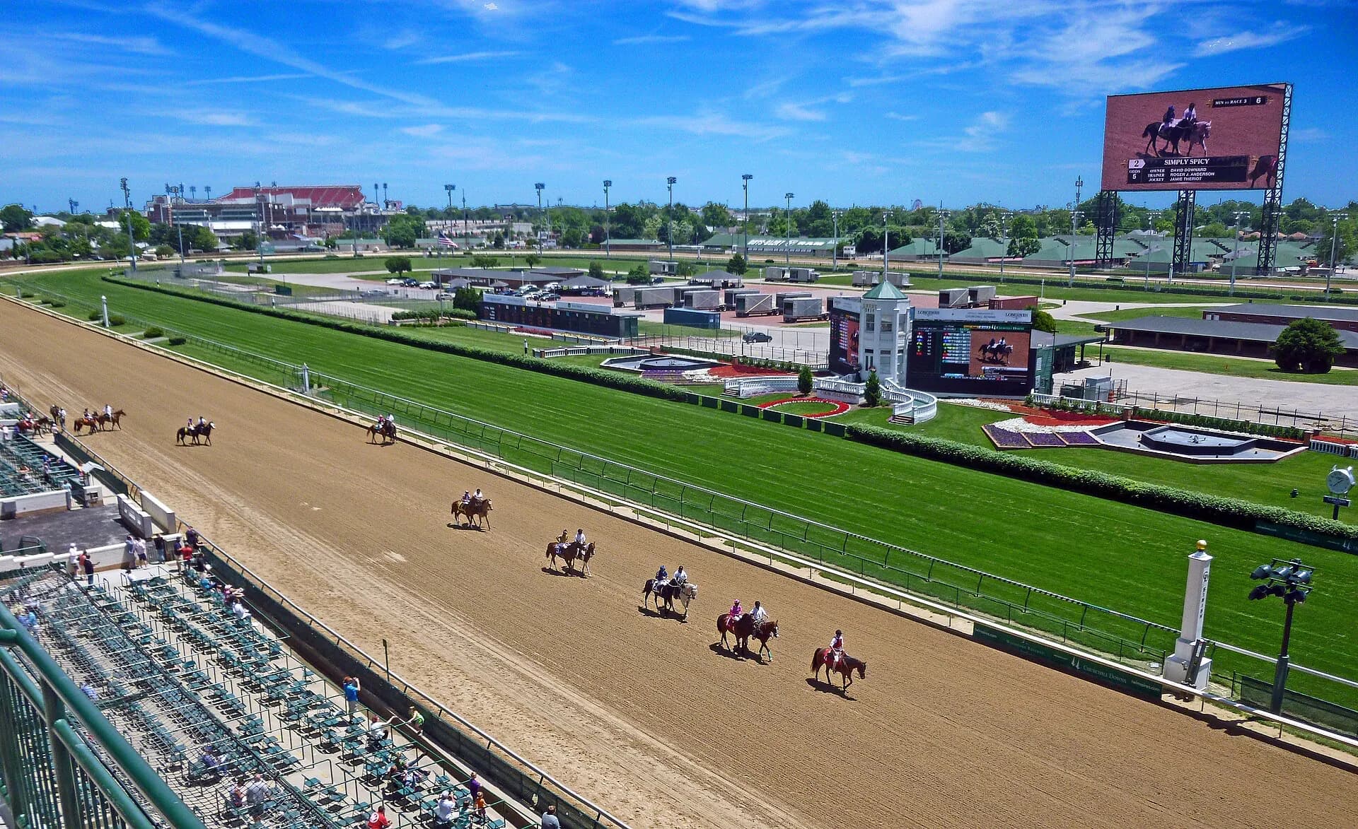 Wide view of Churchill Downs showing the track, infield, and grandstands.