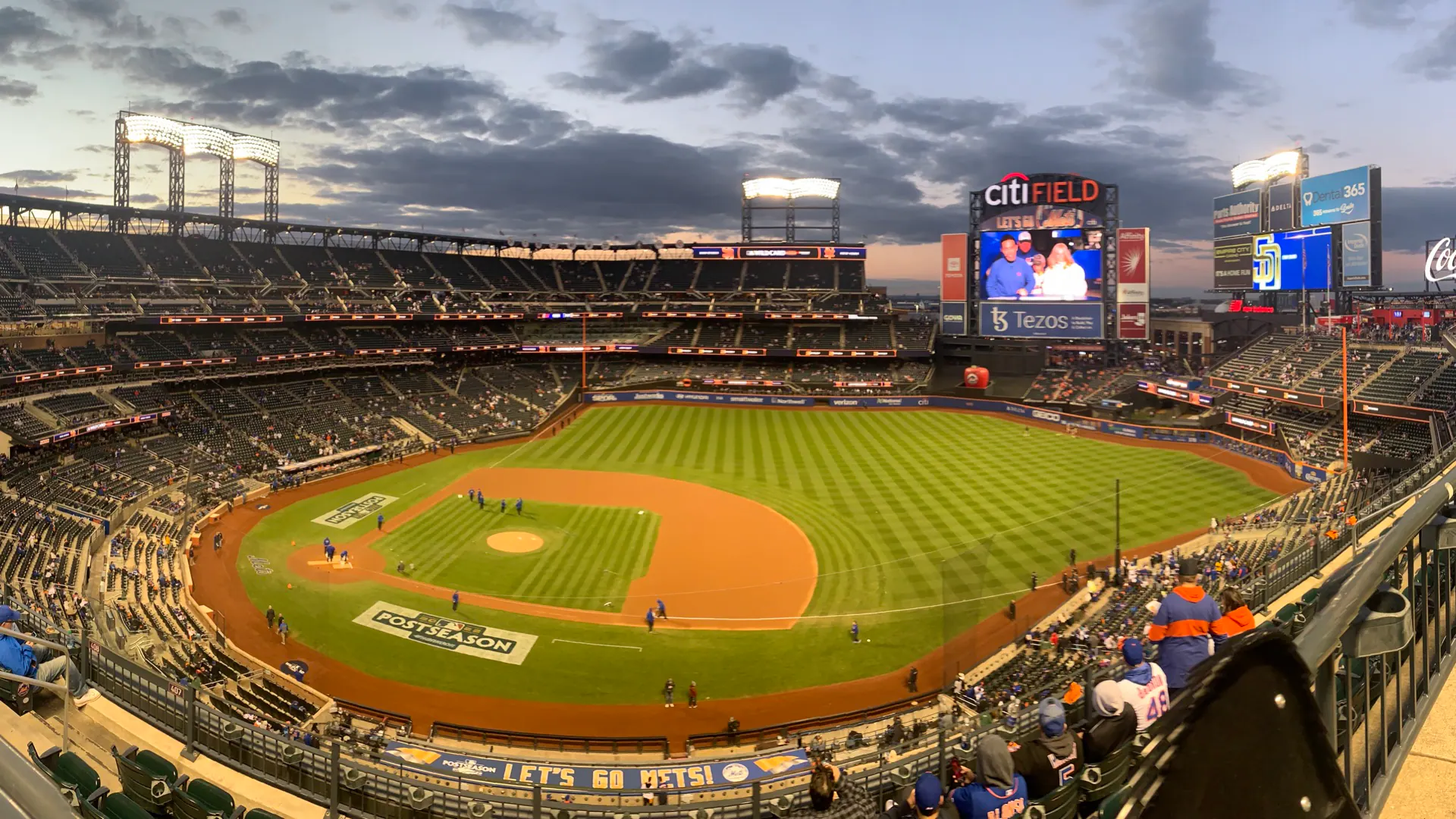 Twilight panorama across Citi Field's full diamond, scoreboards, and seating bowl before a 2022 postseason game.