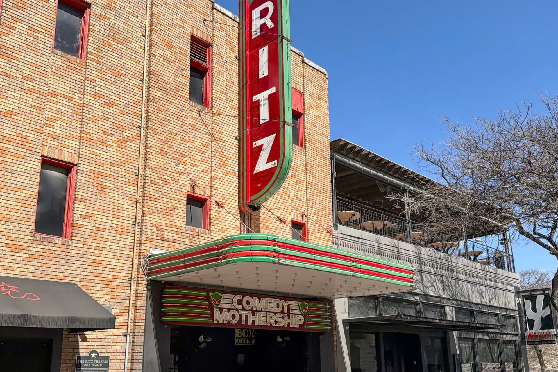 The Comedy Mothership entrance and vertical Ritz sign in daylight.