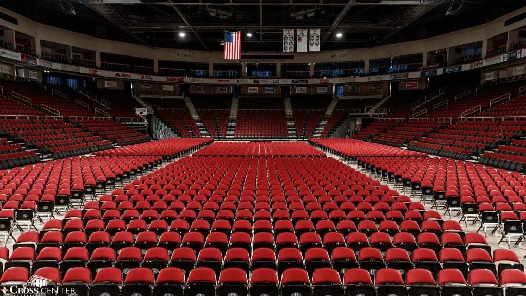 Cross Insurance Center’s red spectator bowl and reserved floor chairs in an official arena photograph published December 2023. Floor seating varies by event; the capture date is not supplied.