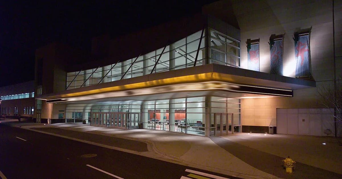 DeVos Performance Hall in Grand Rapids at night, showing the glazed entrance frontage and illuminated canopy. Published on the official venue website; capture date is not confirmed.