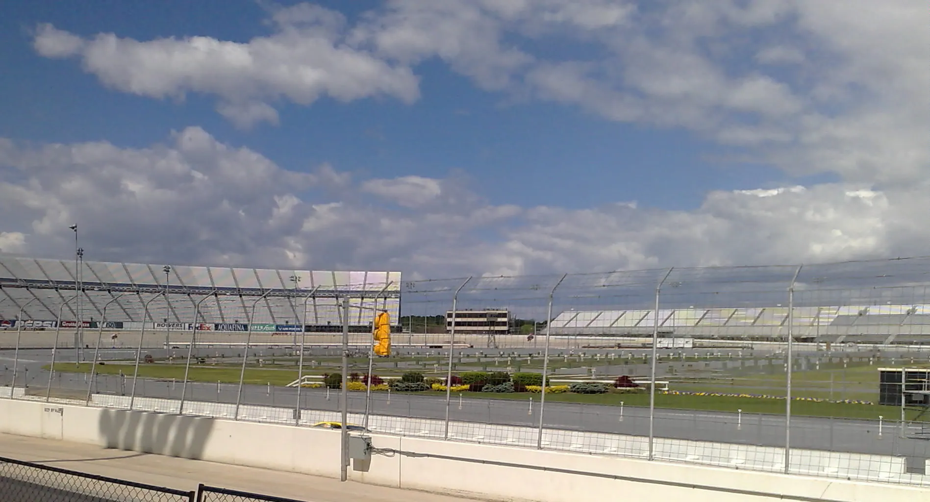 Wide track-level view across Dover Motor Speedway and its grandstands