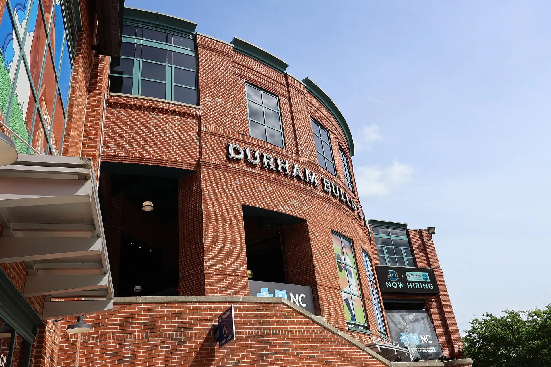 Exterior view of the Durham Bulls Athletic Park entrance and brick facade.