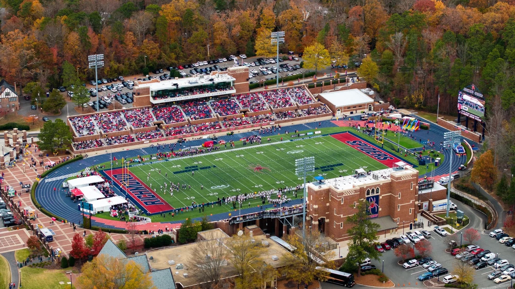 Robins Stadium’s stands and surrounding campus during football, in an official aerial photograph; the playing surface was replaced in summer 2026.