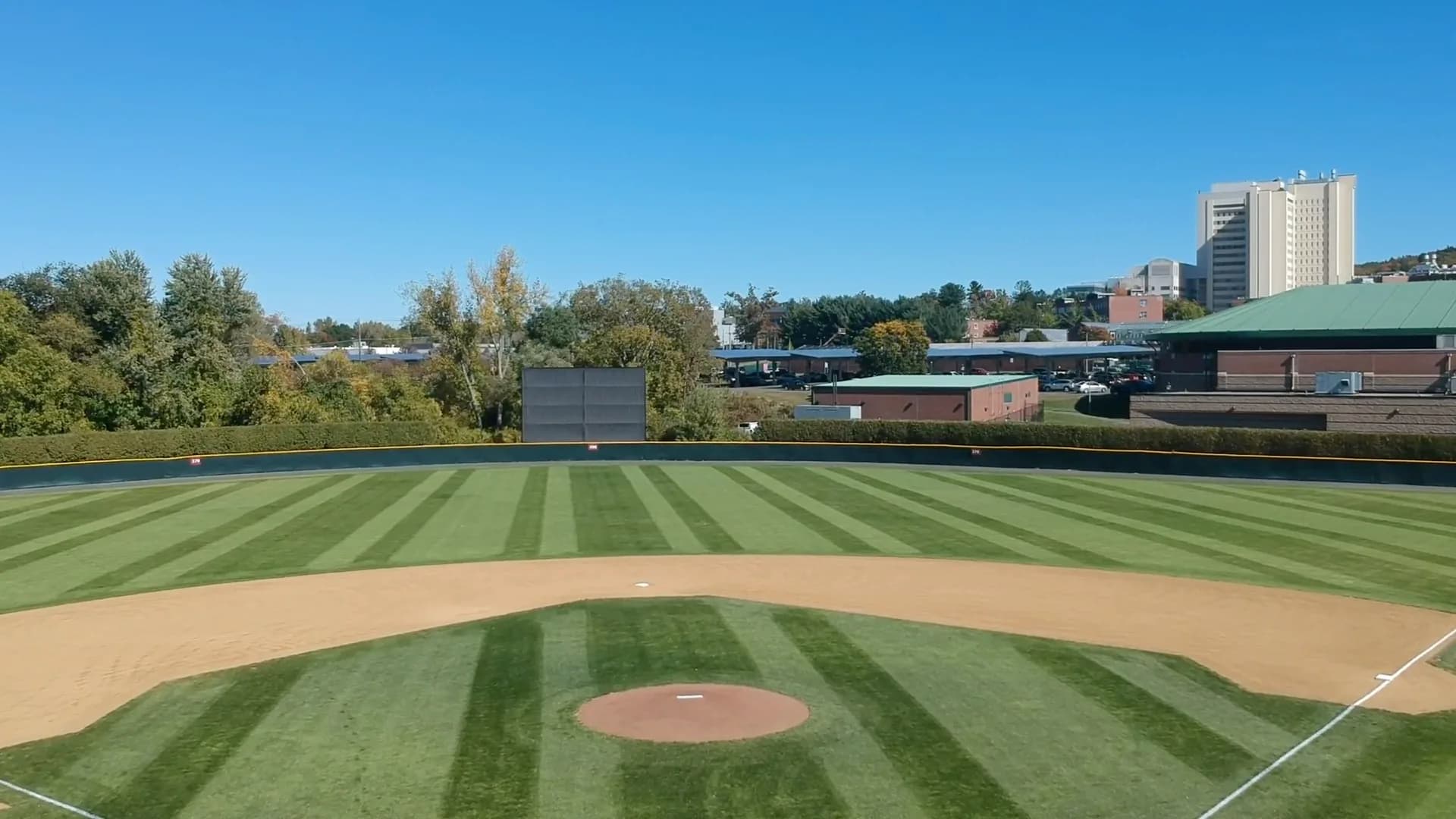 Earl Lorden Field’s complete diamond, outfield and nearby campus buildings in UMass Athletics’ official view labeled for 2020. This earlier-season orientation photograph does not identify individual spectator seats or establish present parking permission.
