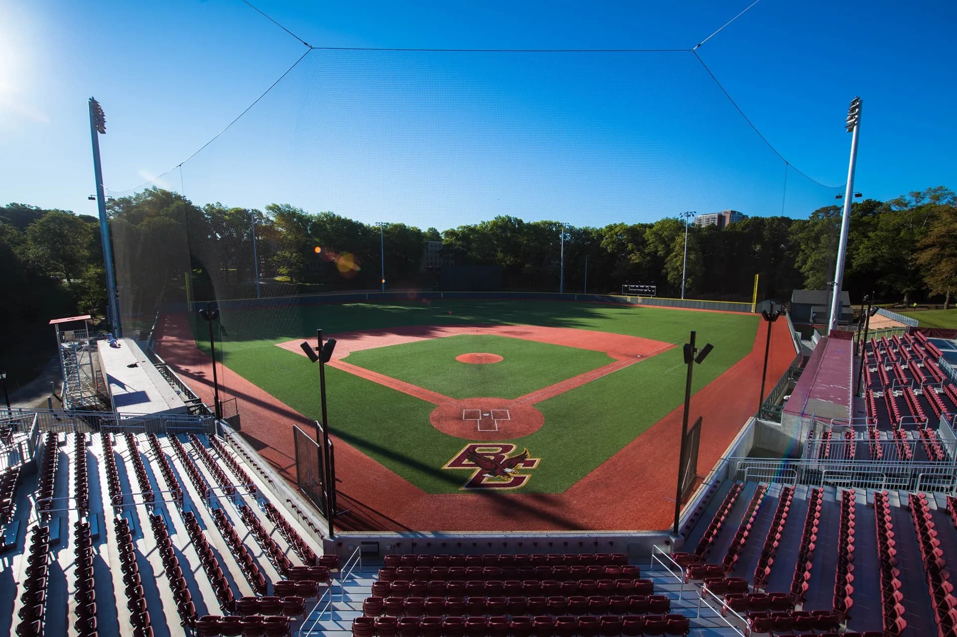 Boston College’s Eddie Pellagrini Diamond at Harrington Athletics Village from behind home plate in the official collection explicitly labeled for 2018. The actual bleachers, aisles and protective netting remain visible; no exact capture day or numbered spectator camera seat is supplied.