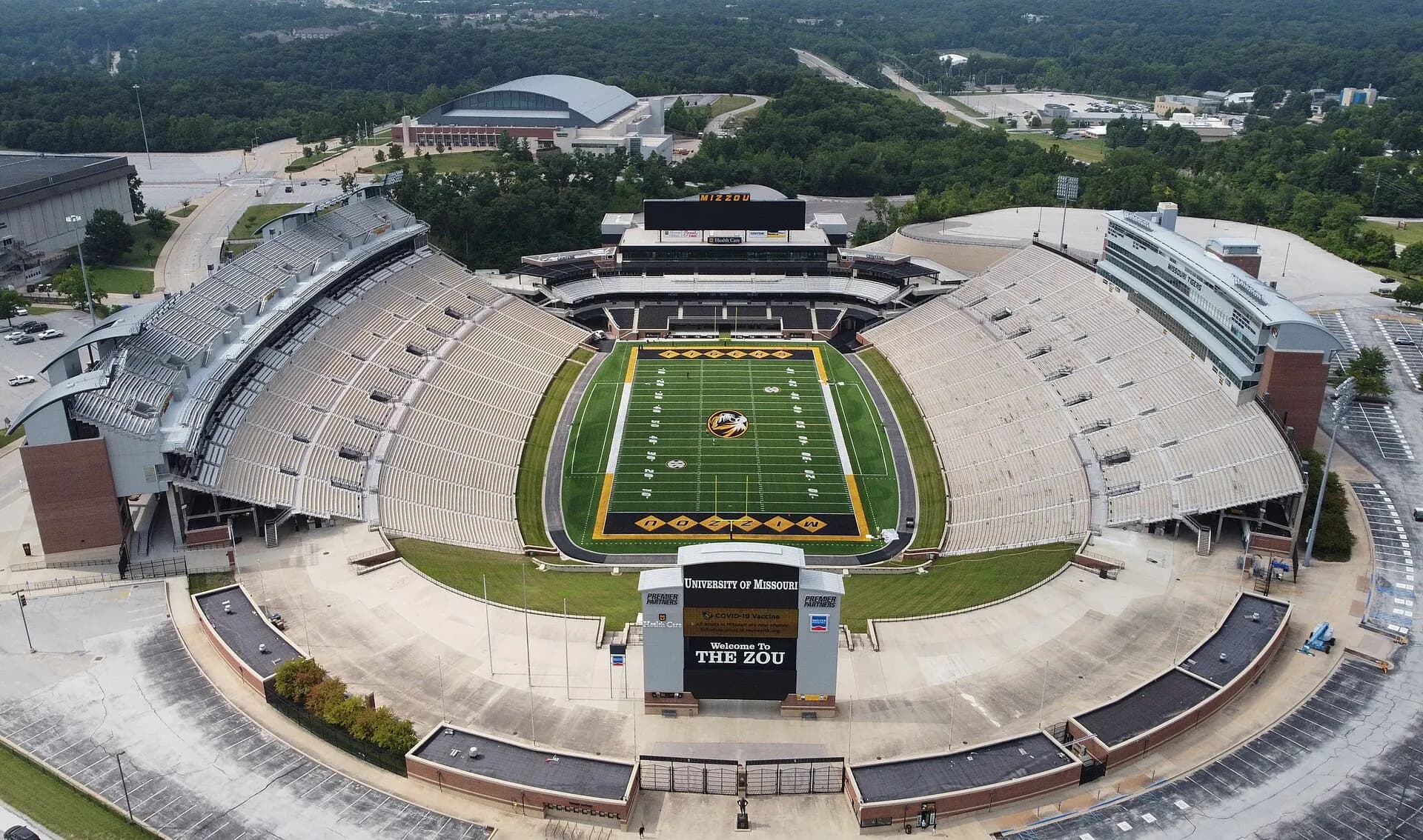 An aerial establishing view of Faurot Field, its full football bowl, and the surrounding Missouri campus.