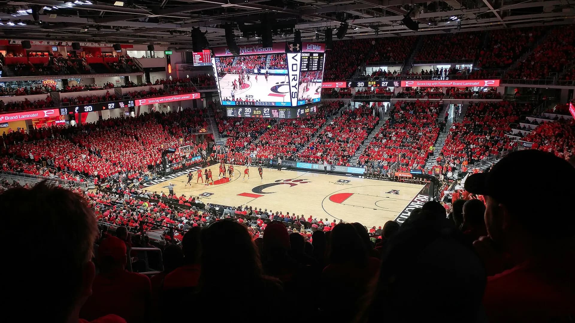A wide post-renovation view of Fifth Third Arena's basketball court, lower bowl, and upper seating.