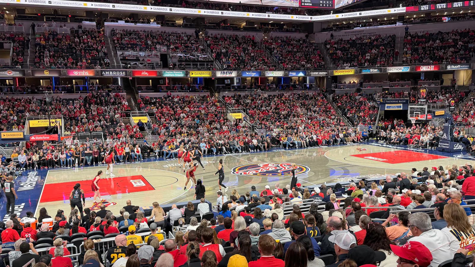 Wide game-night view across Gainbridge Fieldhouse's basketball court and seating bowl during a 2026 Indiana Fever game.