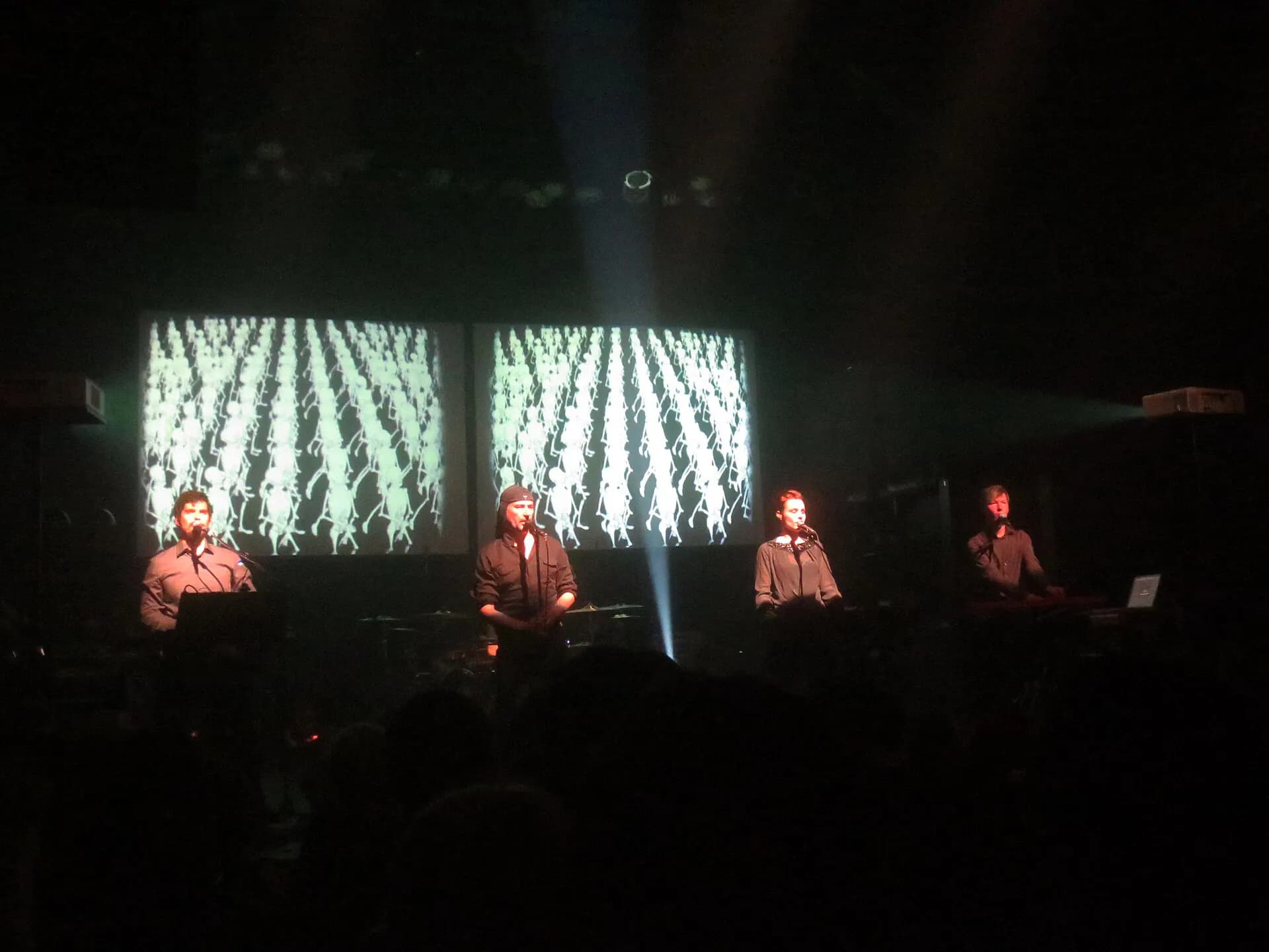 Wide floor-level view across the Gramercy Theatre stage during a live performance, with the crowd and production screens visible.
