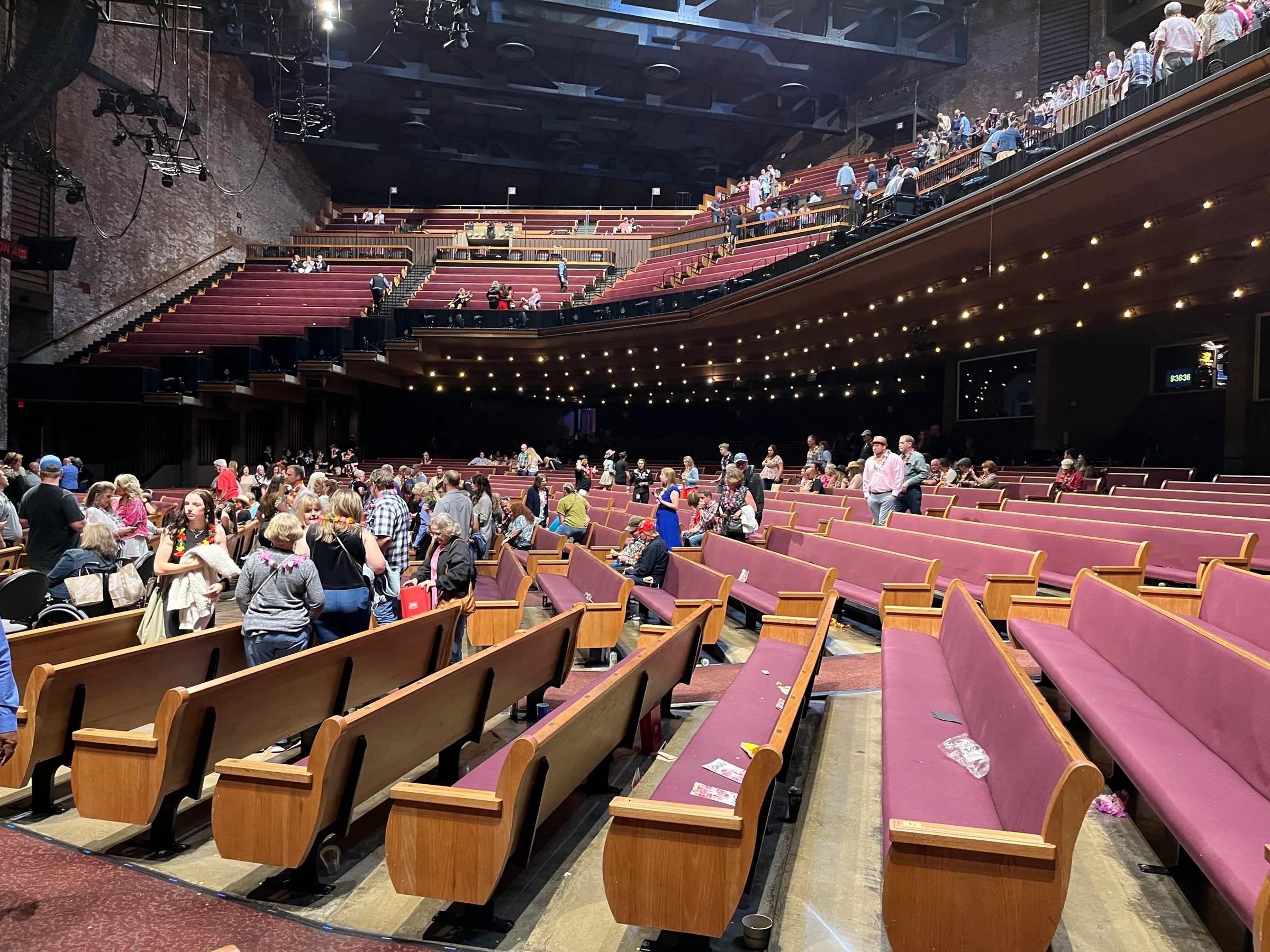 Wide floor-level view of the seating, balcony, and room inside Grand Ole Opry House.