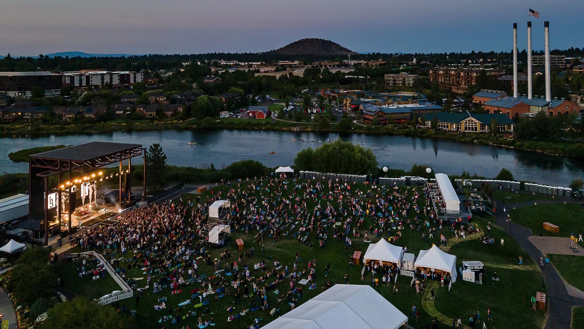 Aerial view of Hayden Homes Amphitheater, its lawn, stage, and Deschutes River setting.