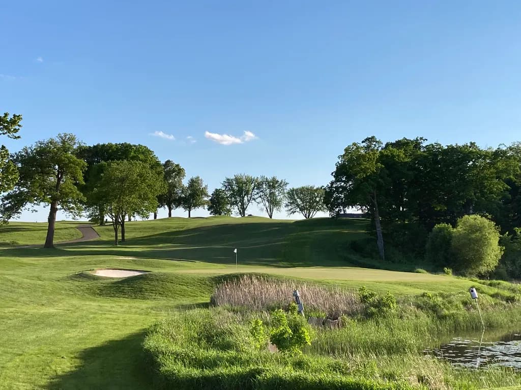 Wide fairway and green view of the tenth hole at Hazeltine National Golf Club