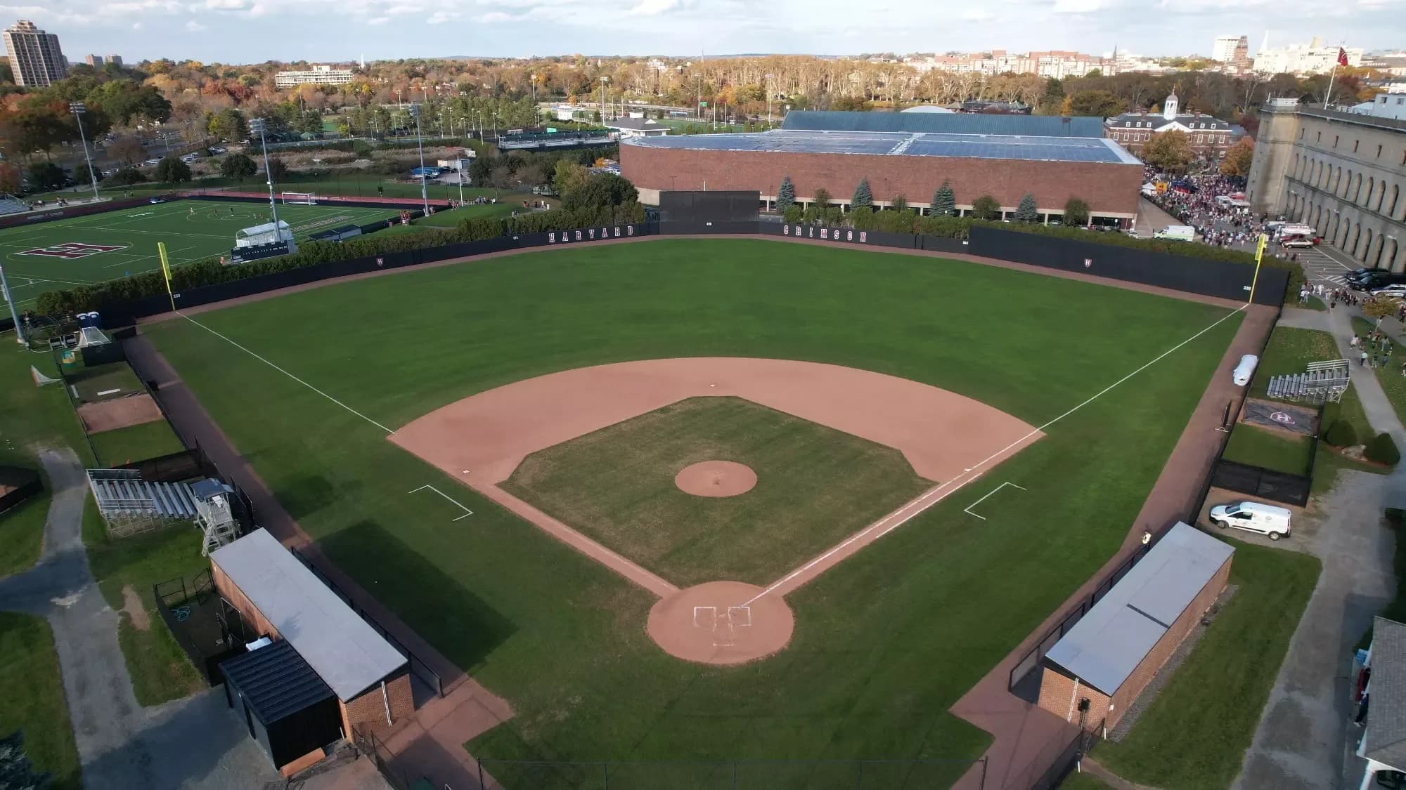 O’Donnell Field’s complete natural-grass diamond and Harvard Stadium backdrop in the current official facility collection. The university documents an infield surface upgrade in fall 2024; this undated aerial is for orientation and does not establish an exact capture date, public field access or a numbered camera seat.