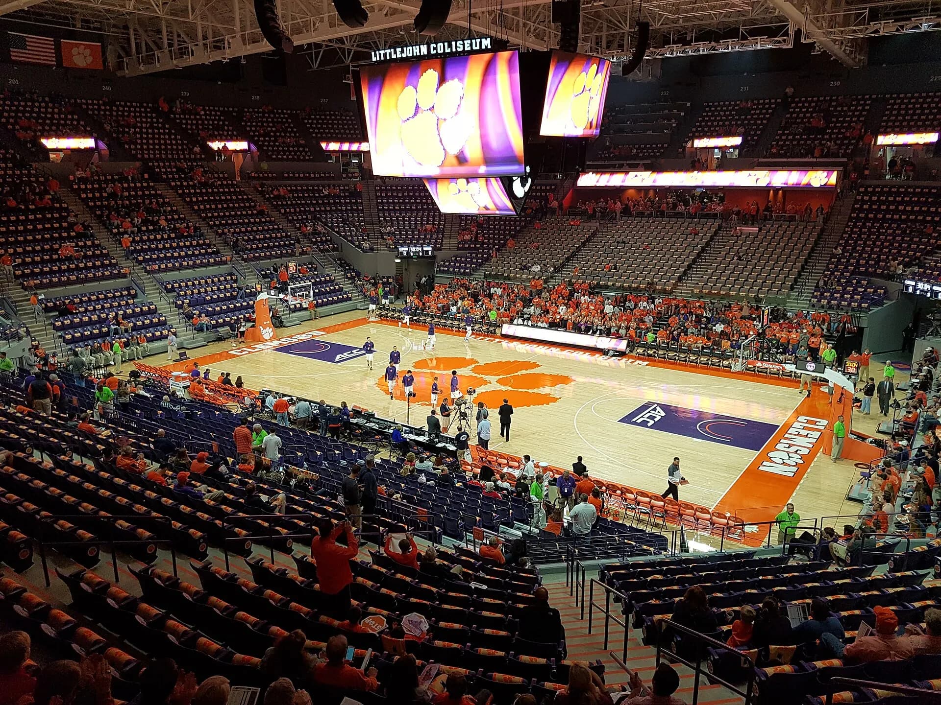 Wide interior view of Littlejohn Coliseum's renovated court, seating bowl, and center videoboard.