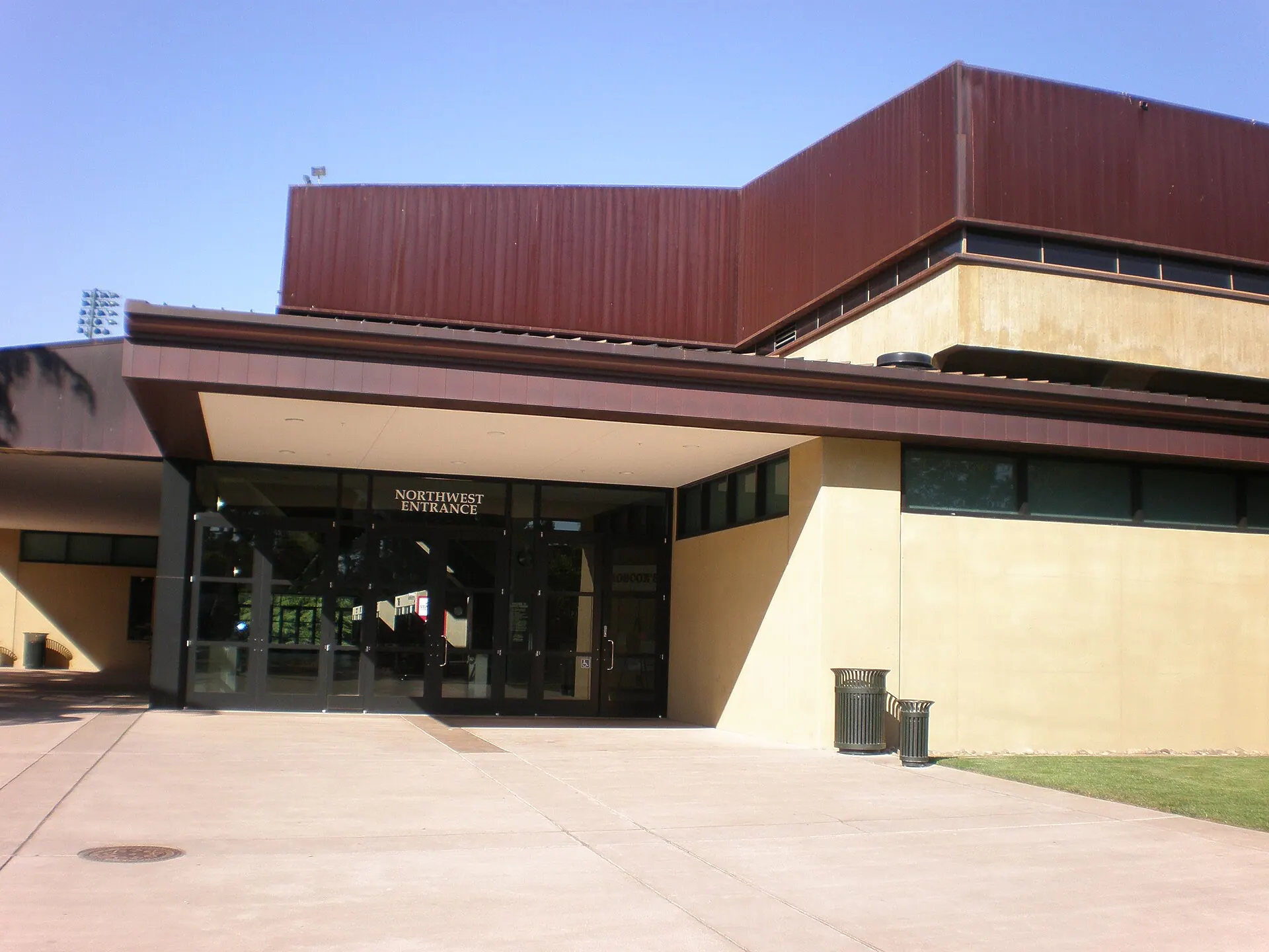 Exterior establishing view of the northwest entrance to Maples Pavilion on Stanford's campus.