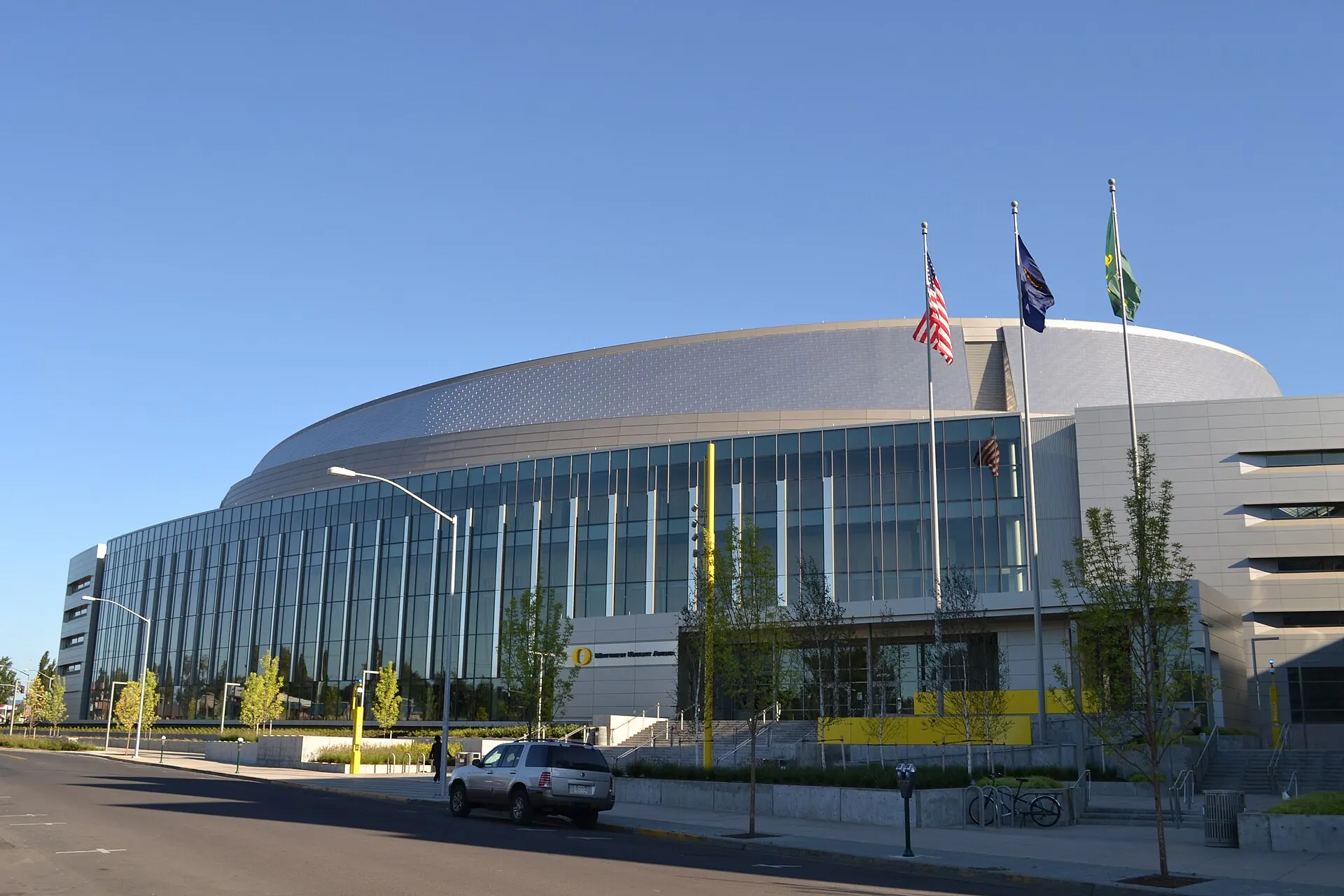 Broad exterior view of Matthew Knight Arena's glass facade and full building volume in Eugene.