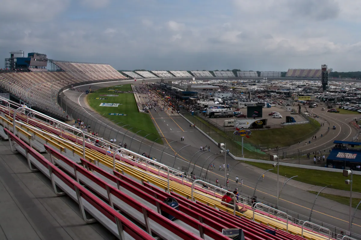 Wide grandstand view across the oval and infield at Michigan International Speedway