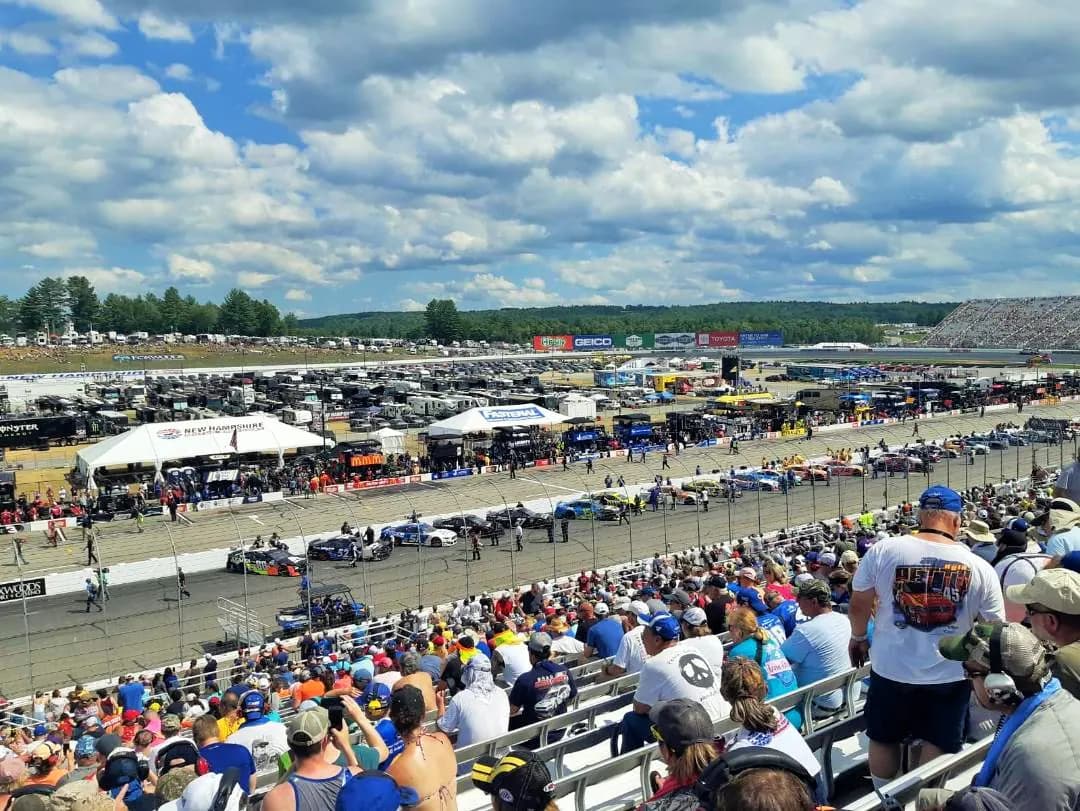 Wide spectator view across New Hampshire Motor Speedway on race day