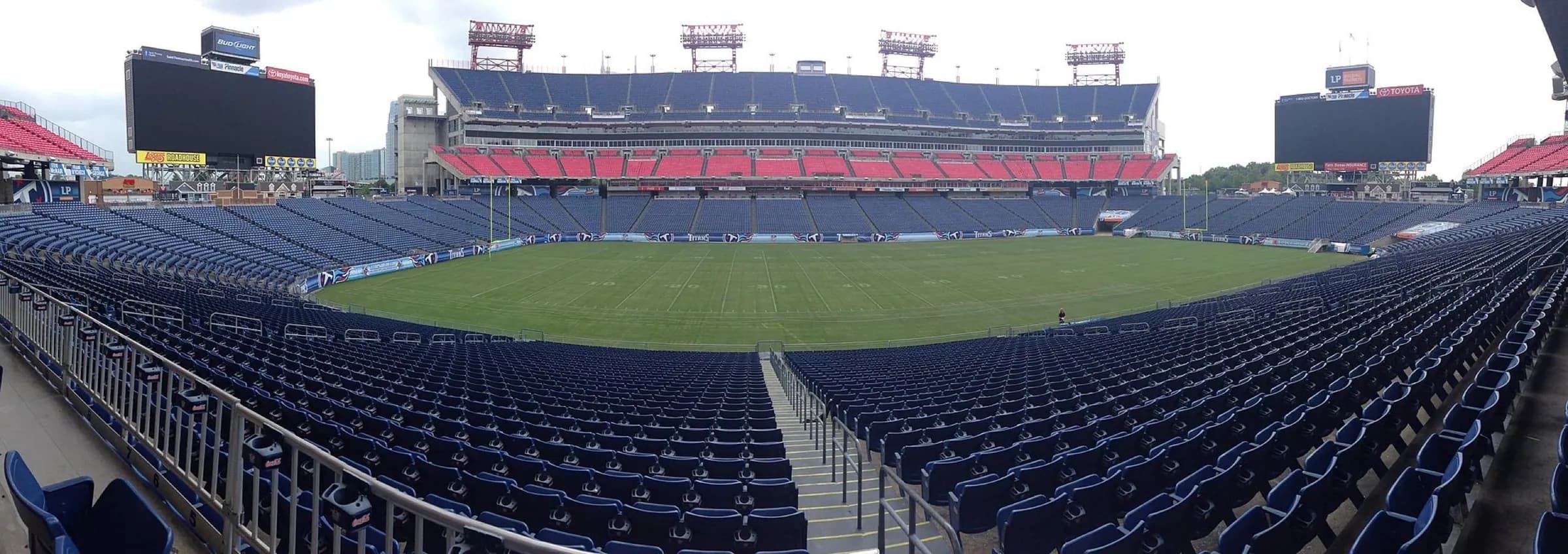 Super-wide view from the stands across the field and full seating bowl at Nissan Stadium.
