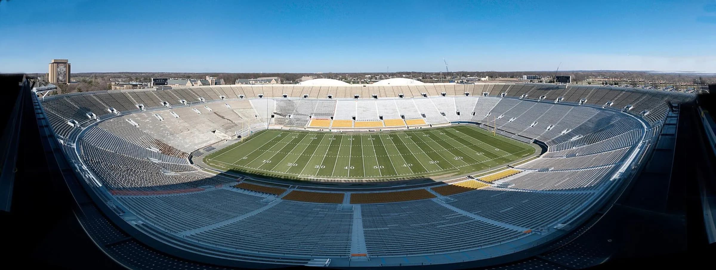 Wide panorama across Notre Dame Stadium's field and seating bowl.