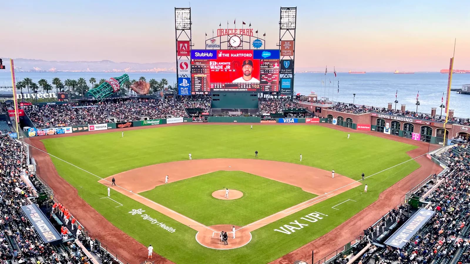 Wide view across Oracle Park's field, scoreboard, and San Francisco Bay during a Giants game.