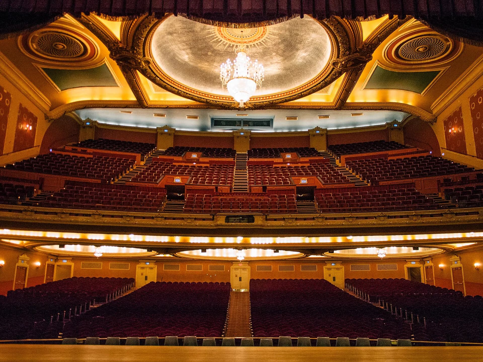 The Orpheum Theater's full Omaha auditorium and layered seating viewed from the stage.