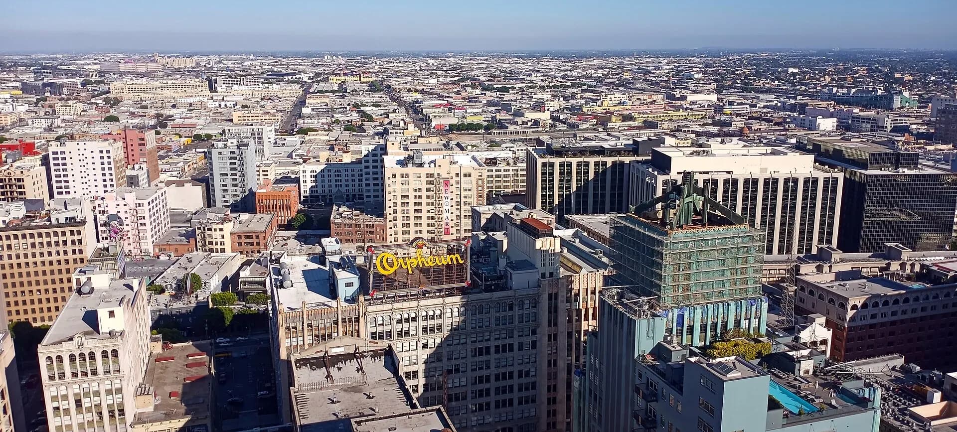 An elevated view of the Orpheum Theatre facade and Broadway streetscape in Los Angeles.