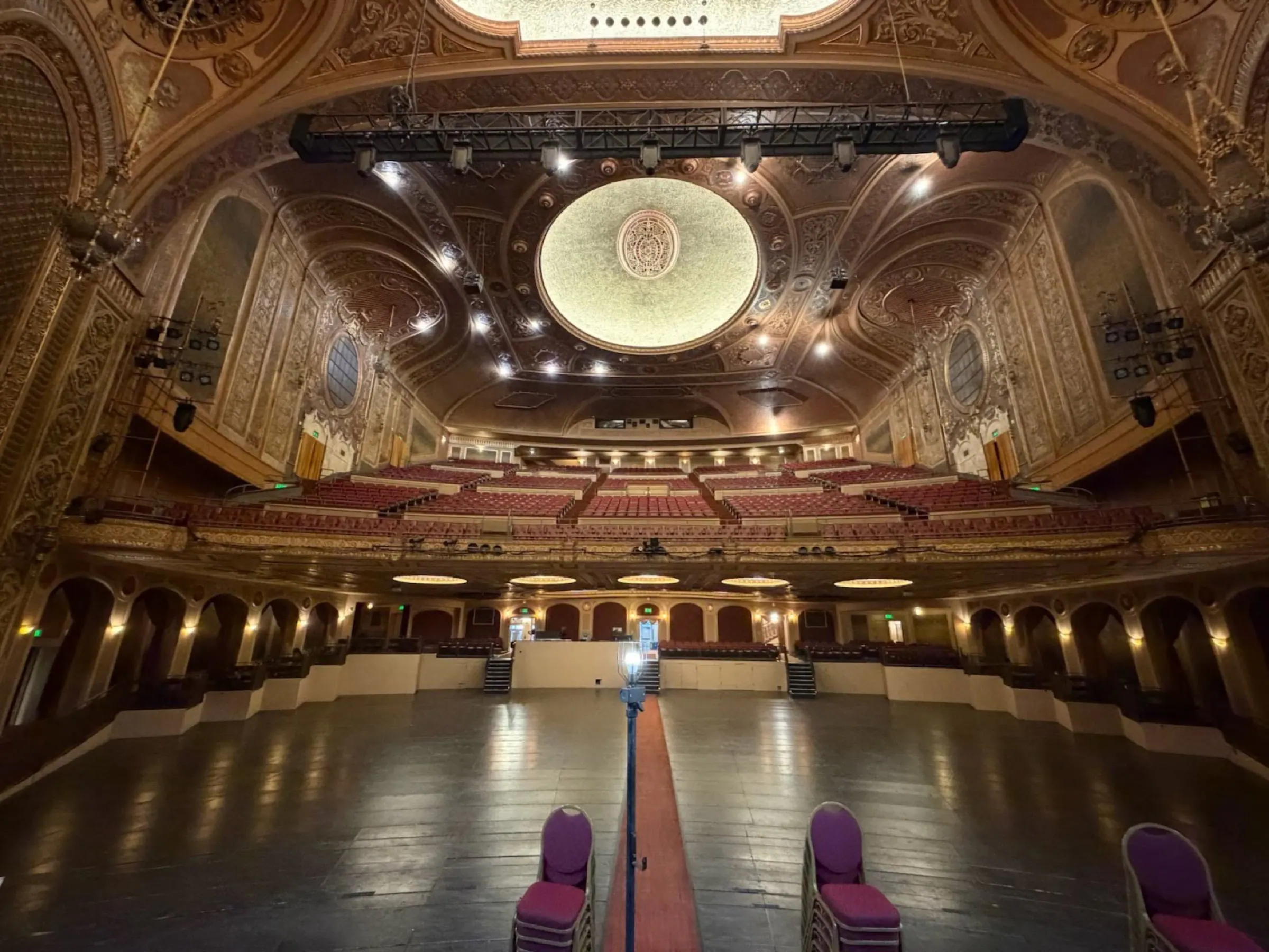 Empty ornate Paramount Theatre seating space with ceiling details visible.