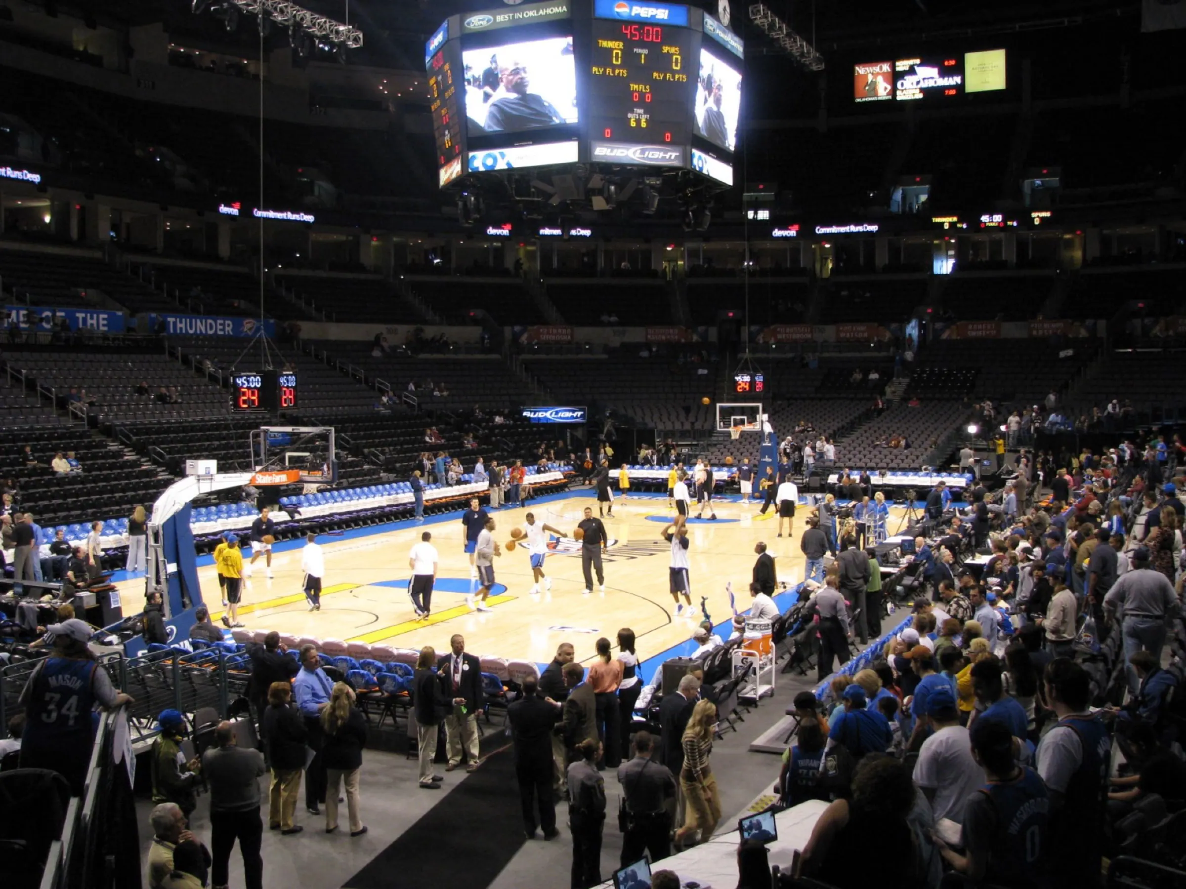 Basketball court and occupied seating bowl inside Paycom Center before a game.
