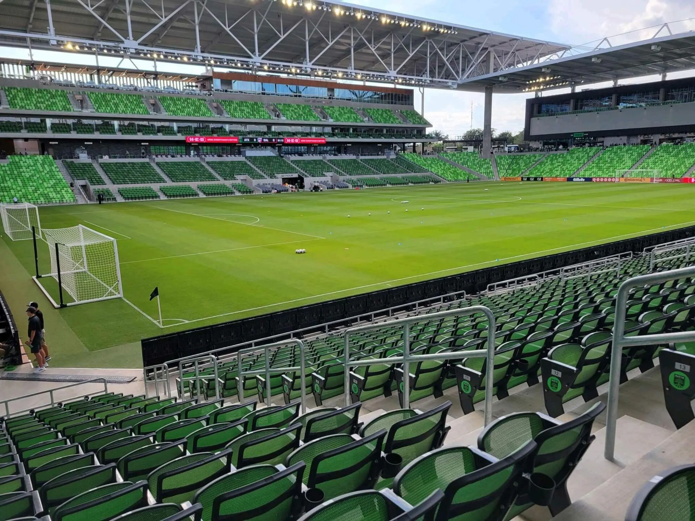 Fan-perspective match view across Q2 Stadium's pitch, seating, and video board.