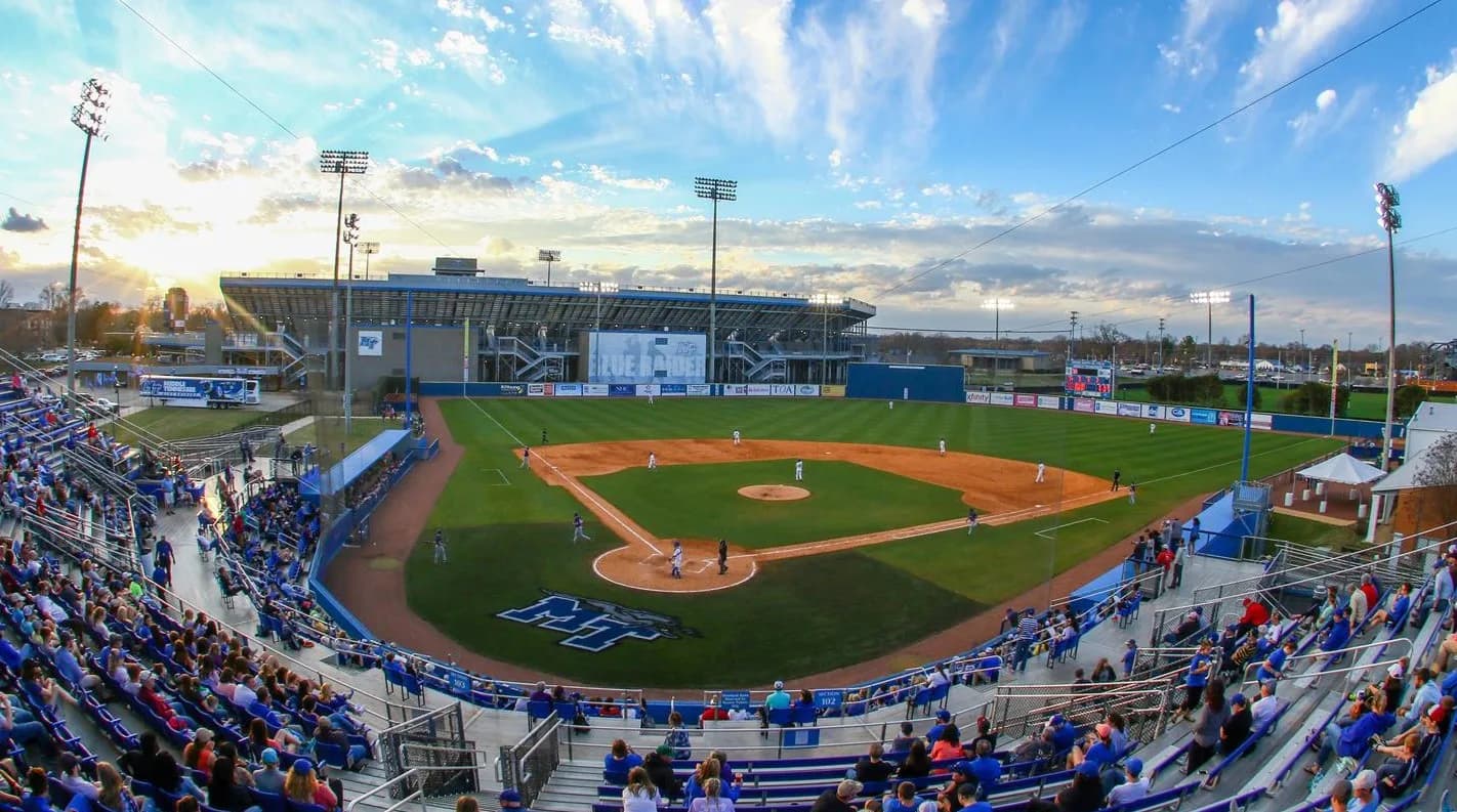 Reese Smith Jr. Field’s occupied seating bowl, diamond and surrounding campus in Middle Tennessee Athletics’ earlier-season collection. Netting, foreground seats and railings remain visible. No exact capture date or numbered spectator camera seat is supplied.