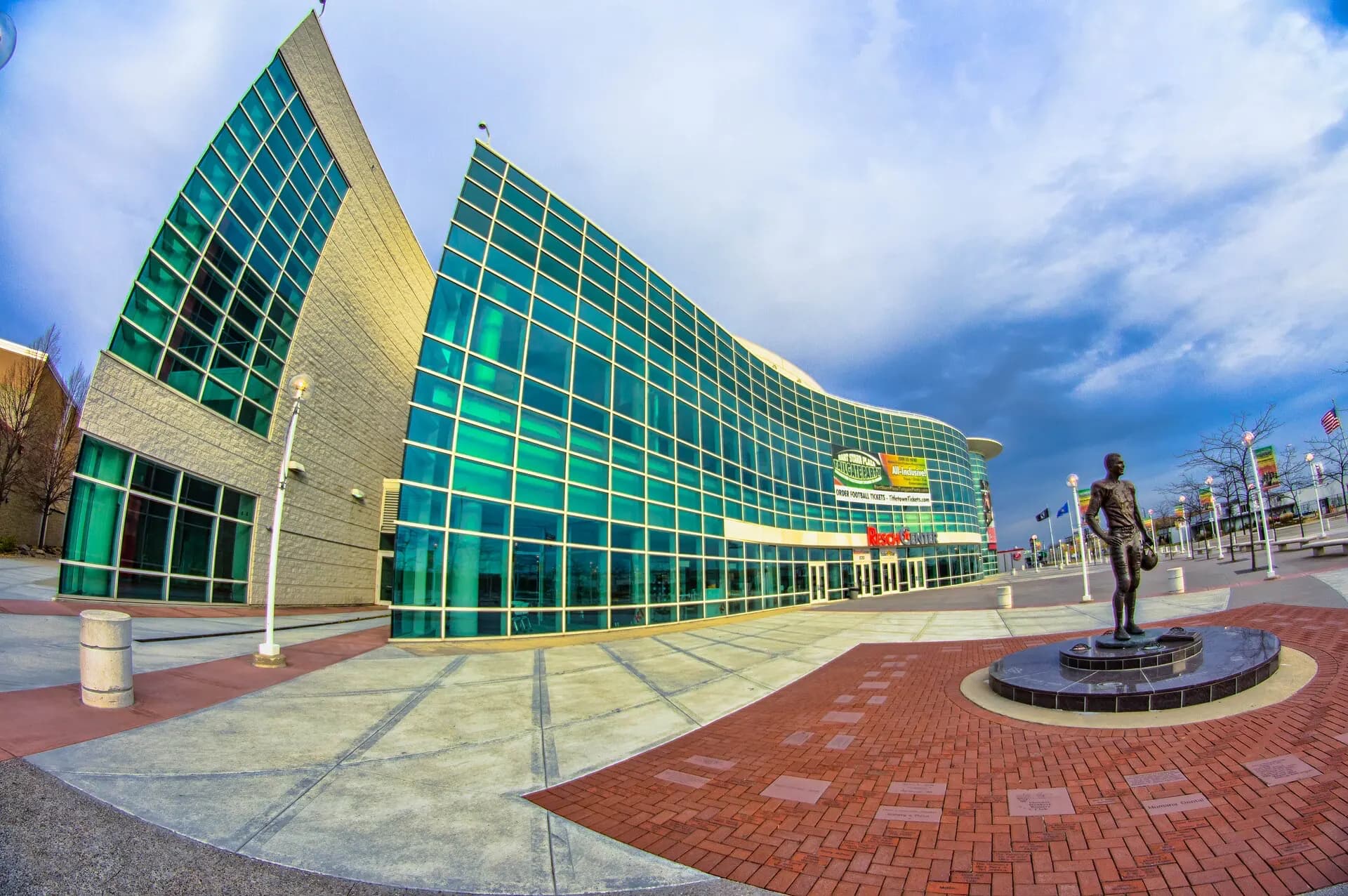 A wide-angle view of the glass facade and plaza outside Resch Center.