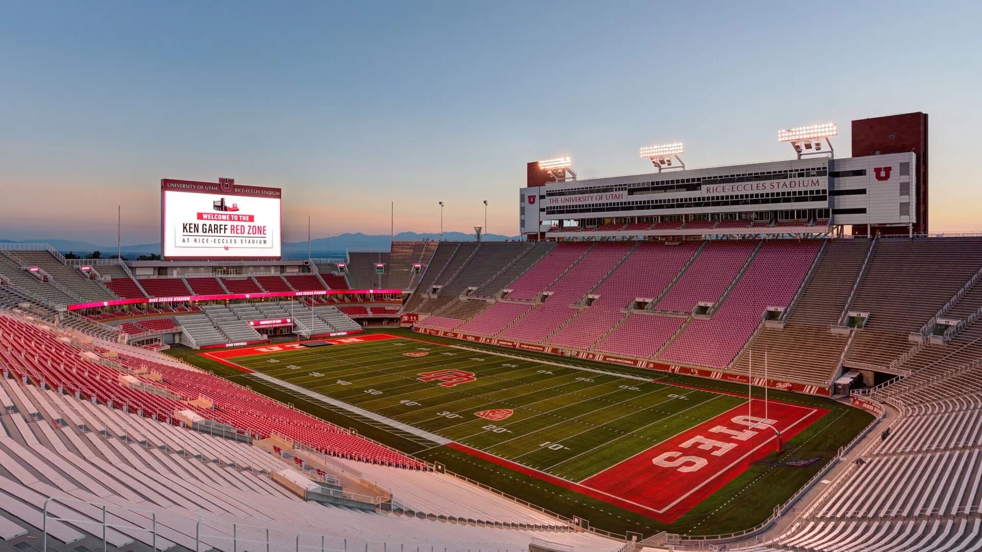 Wide sunset view across the field and seating bowl at Rice-Eccles Stadium.