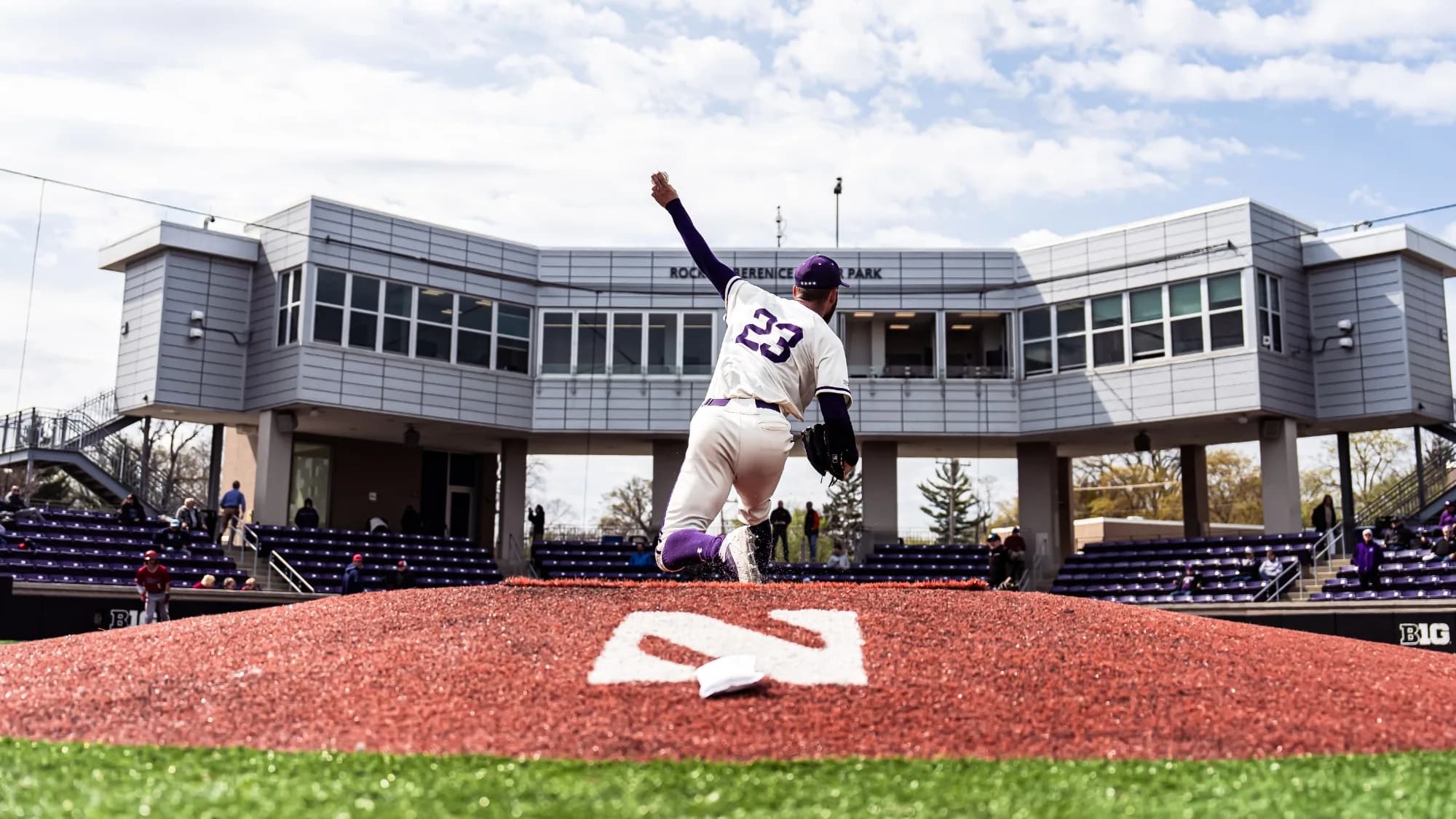 Rocky and Berenice Miller Park’s occupied purple chairback bowl, protective netting and press-box frontage during Northwestern’s April 22, 2025 game against UIC. Photograph by Ryan Kuttler/Northwestern Athletics. This field-level image does not grant spectator playing-surface access or assign a camera seat.