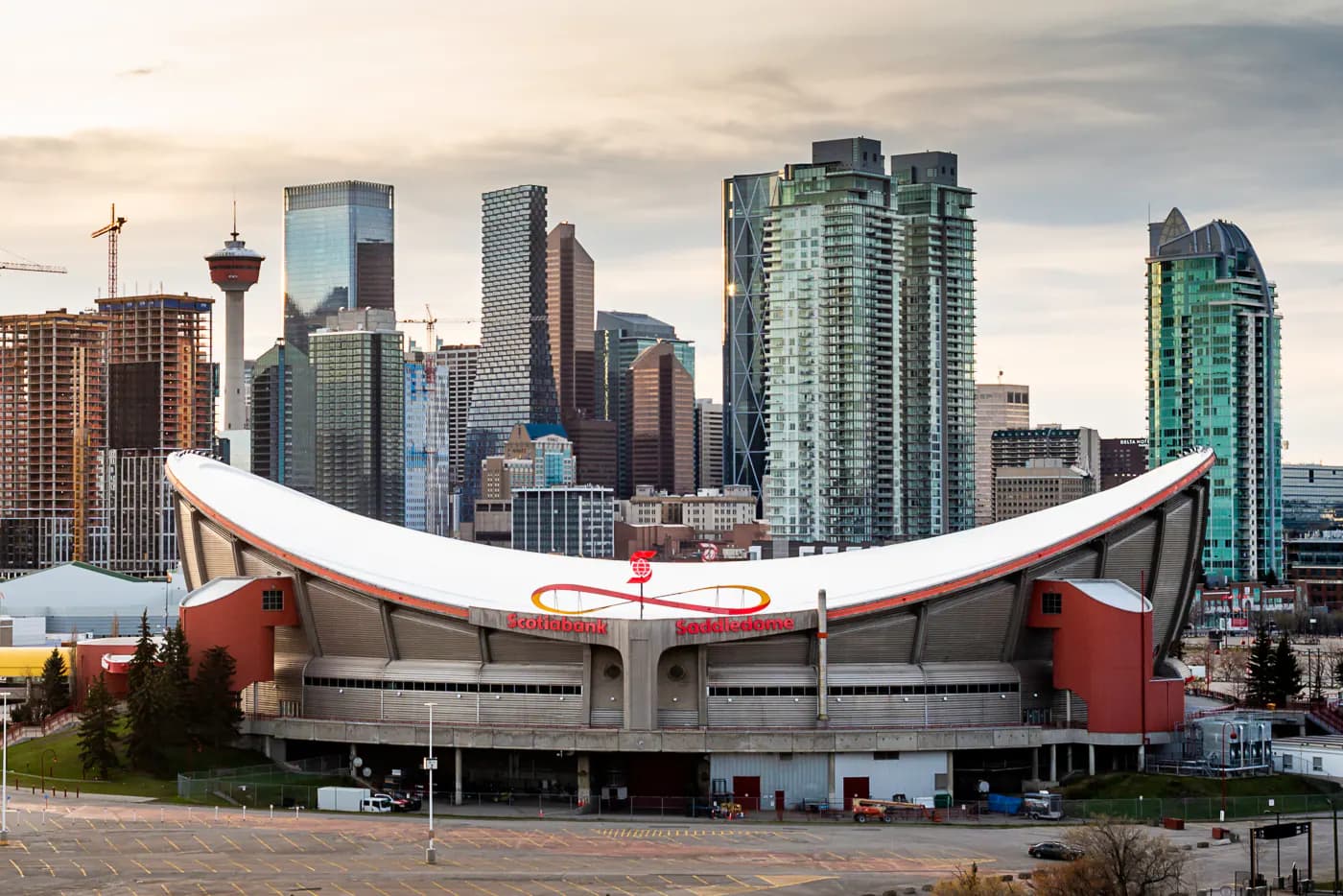 Iconic full exterior of the Scotiabank Saddledome and Calgary skyline