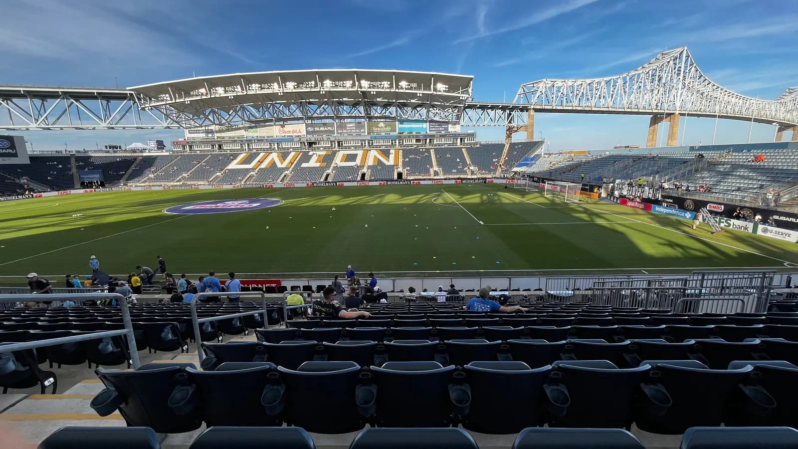 Wide interior view of Subaru Park with the soccer pitch, Union seating, and Commodore Barry Bridge.