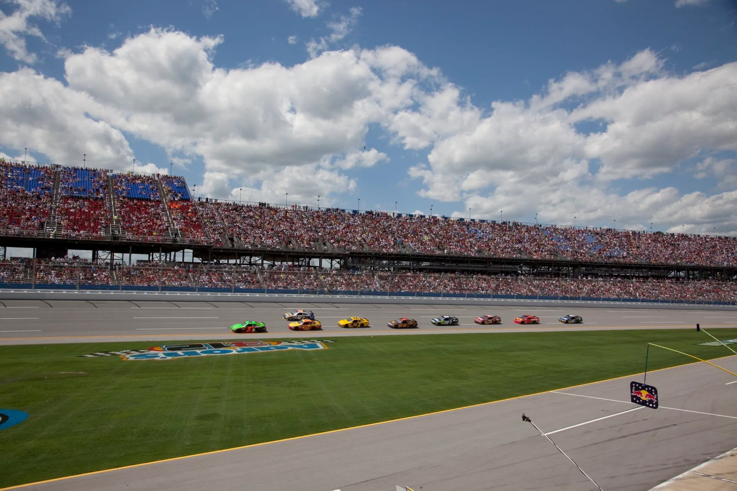 Wide view of the Talladega racing surface and packed grandstands.
