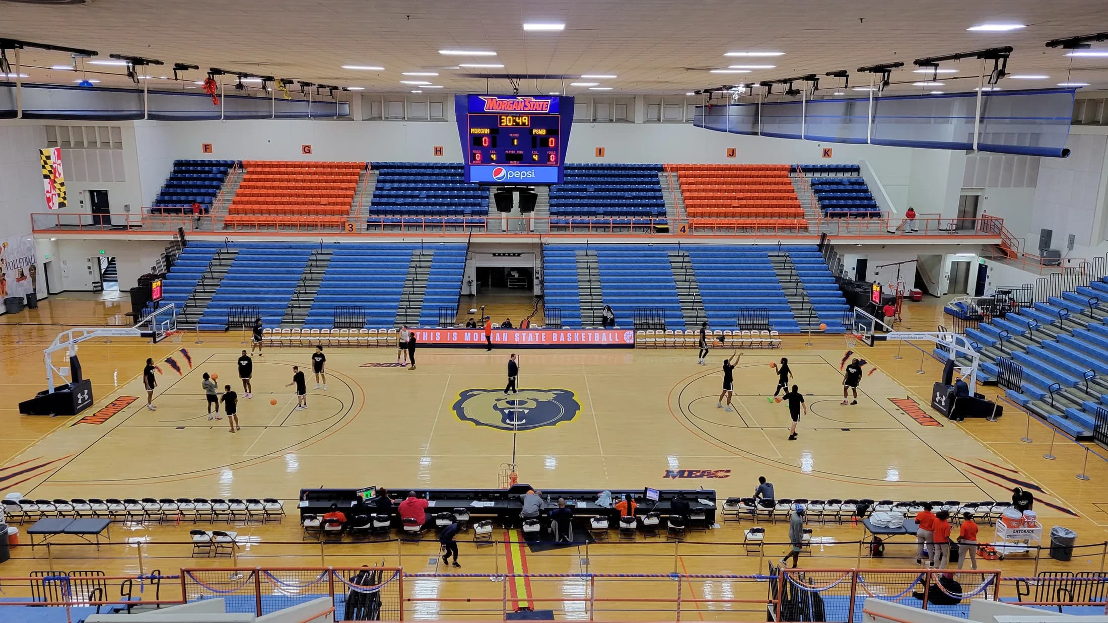 Hill Field House’s basketball court, blue lower bleachers and orange/blue upper seating during the November 12, 2023 visit documented by Stadium and Arena Visits. This dated general venue view does not establish the current event’s seat allocation.