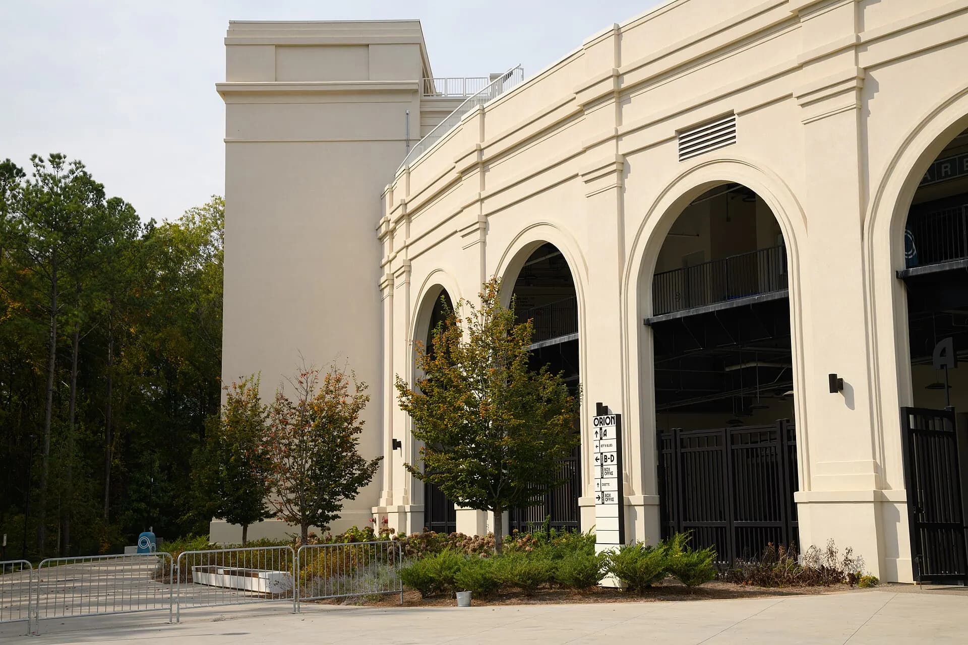 The white arches and exterior entrance of The Orion Amphitheater in Huntsville.