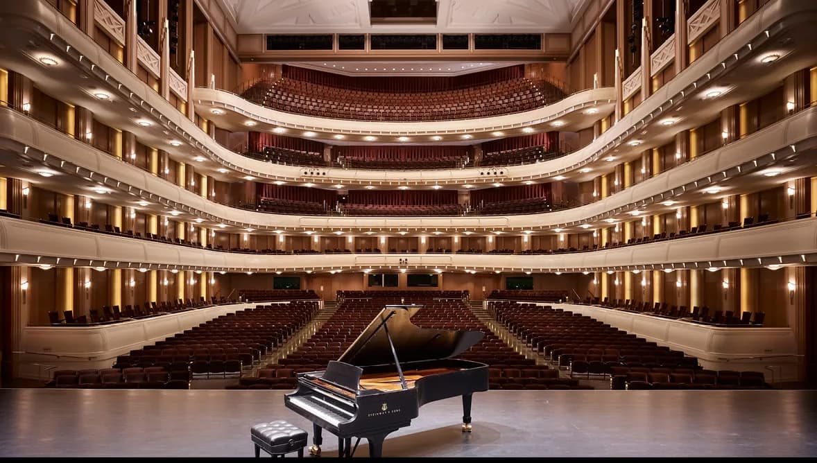 Reynolds Hall at The Smith Center, looking from the stage past a grand piano toward the orchestra, horseshoe balconies and side boxes. This undated architectural photograph is currently used on the official Reynolds Hall page; it does not show Myron’s or Troesh Studio Theater, or identify a spectator seat.